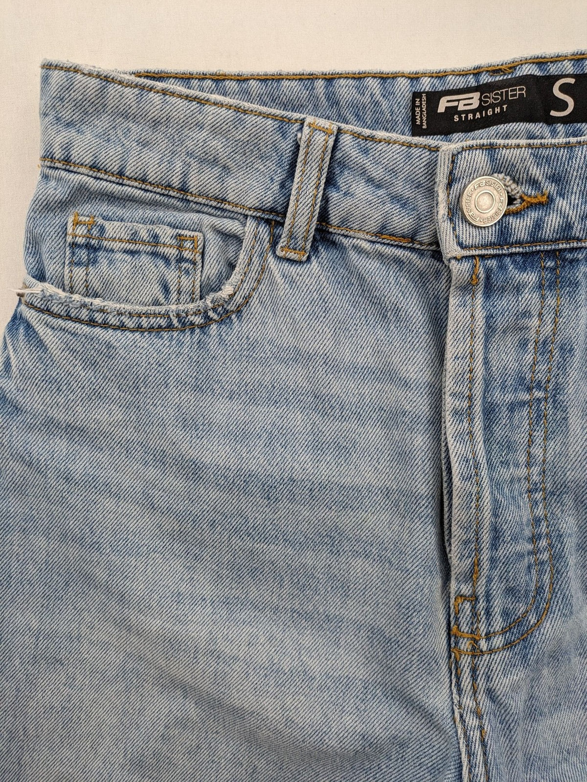 FB Sister blue straight leg jeans high rise with distressed detailing and button fly.