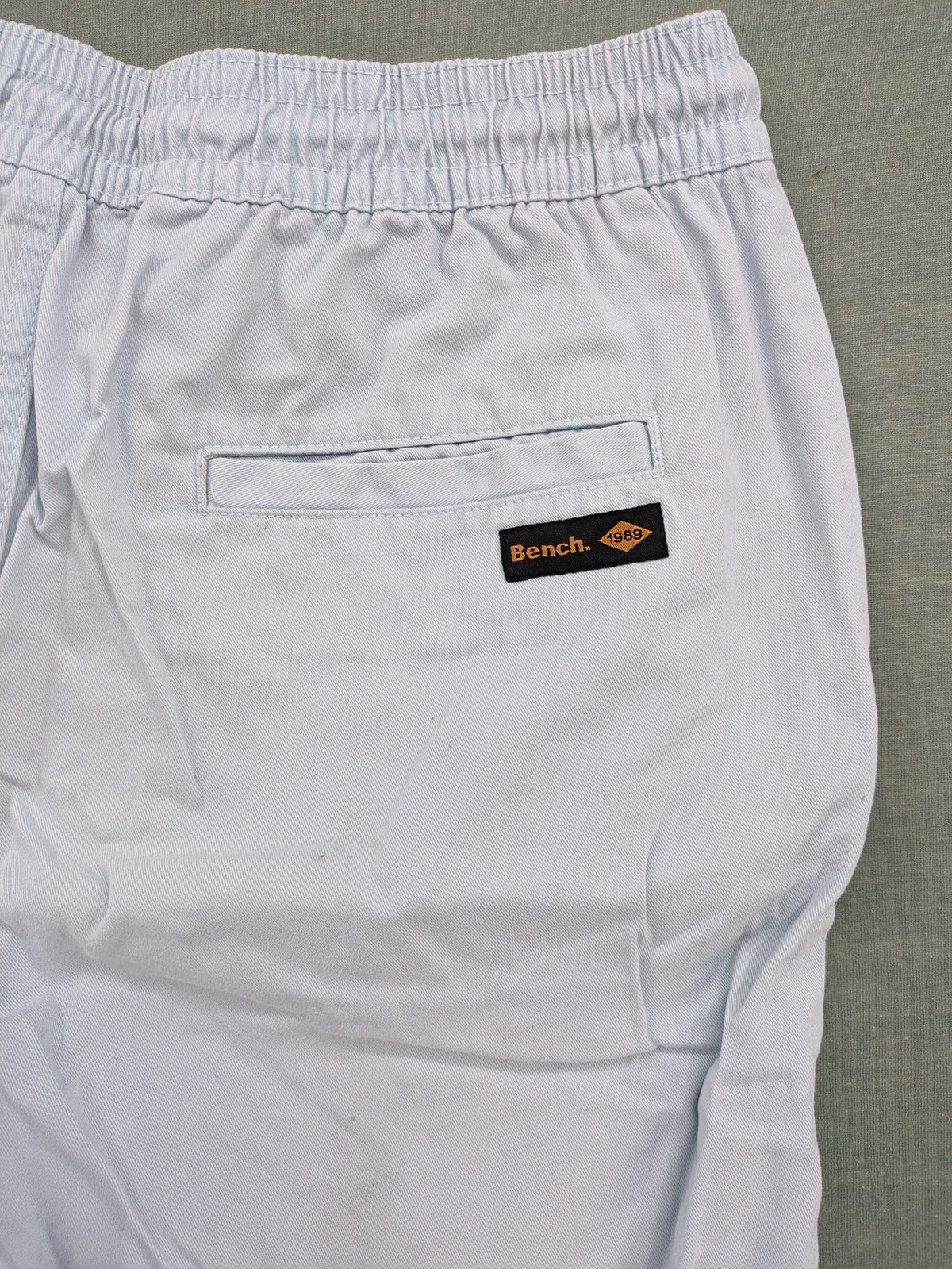 Bench blue shorts with elastic waistband, drawstring, and multiple pockets.