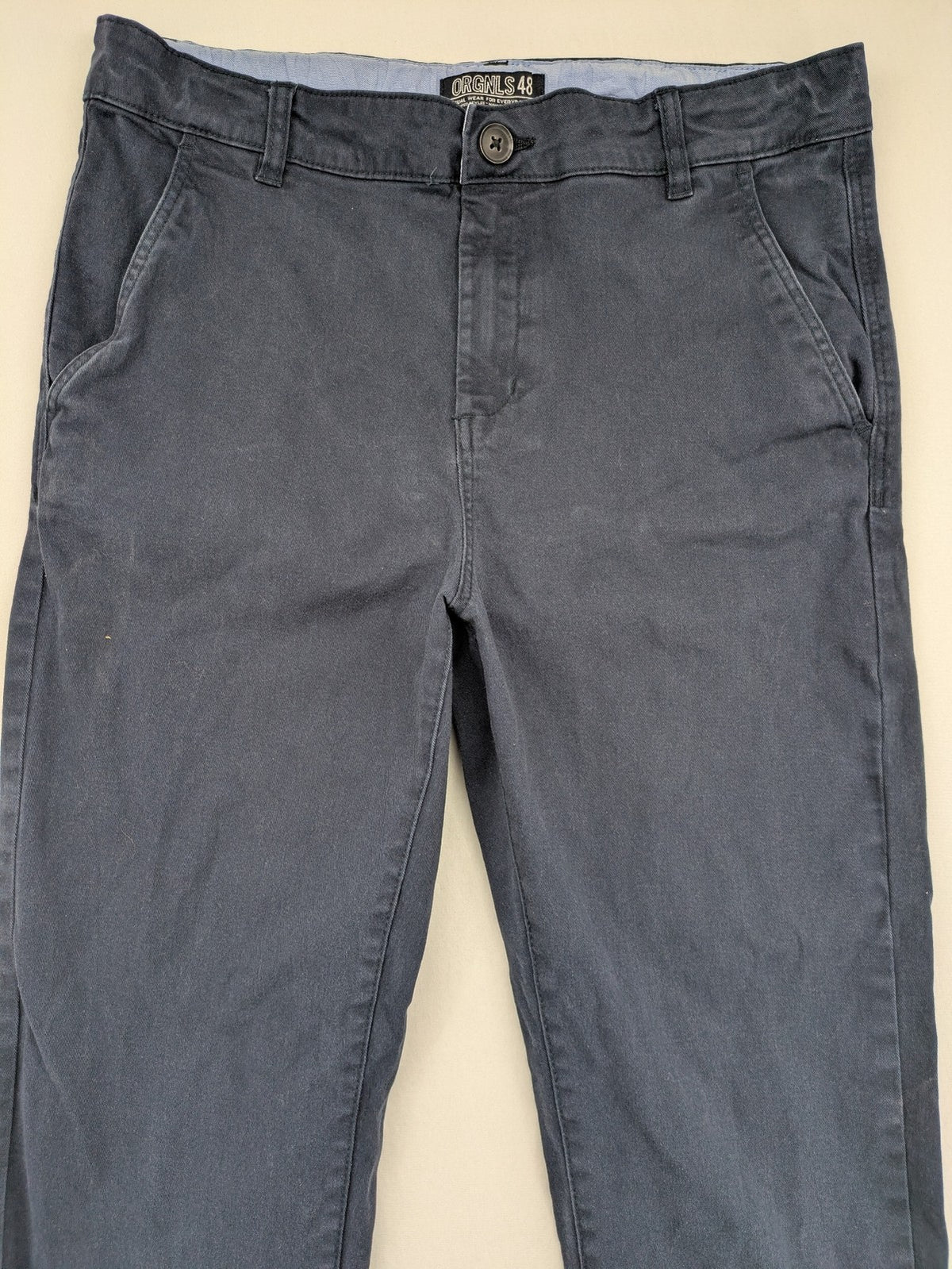 H&M navy chino pants with stretch, classic design, soft cotton blend material.