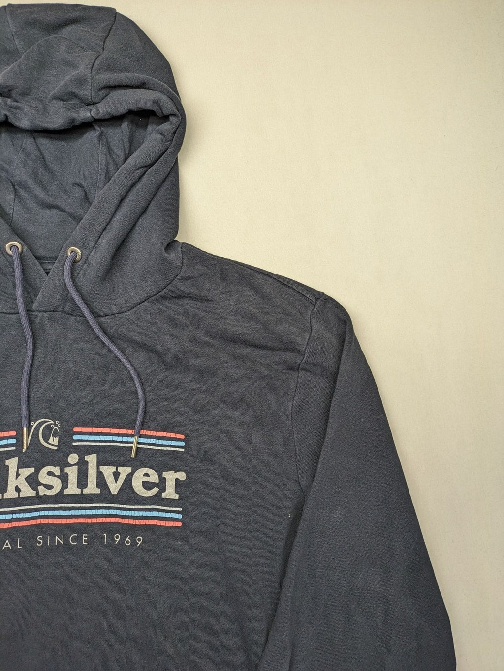 Quiksilver grey hoodie with logo graphic, kangaroo pocket, and adjustable hood.