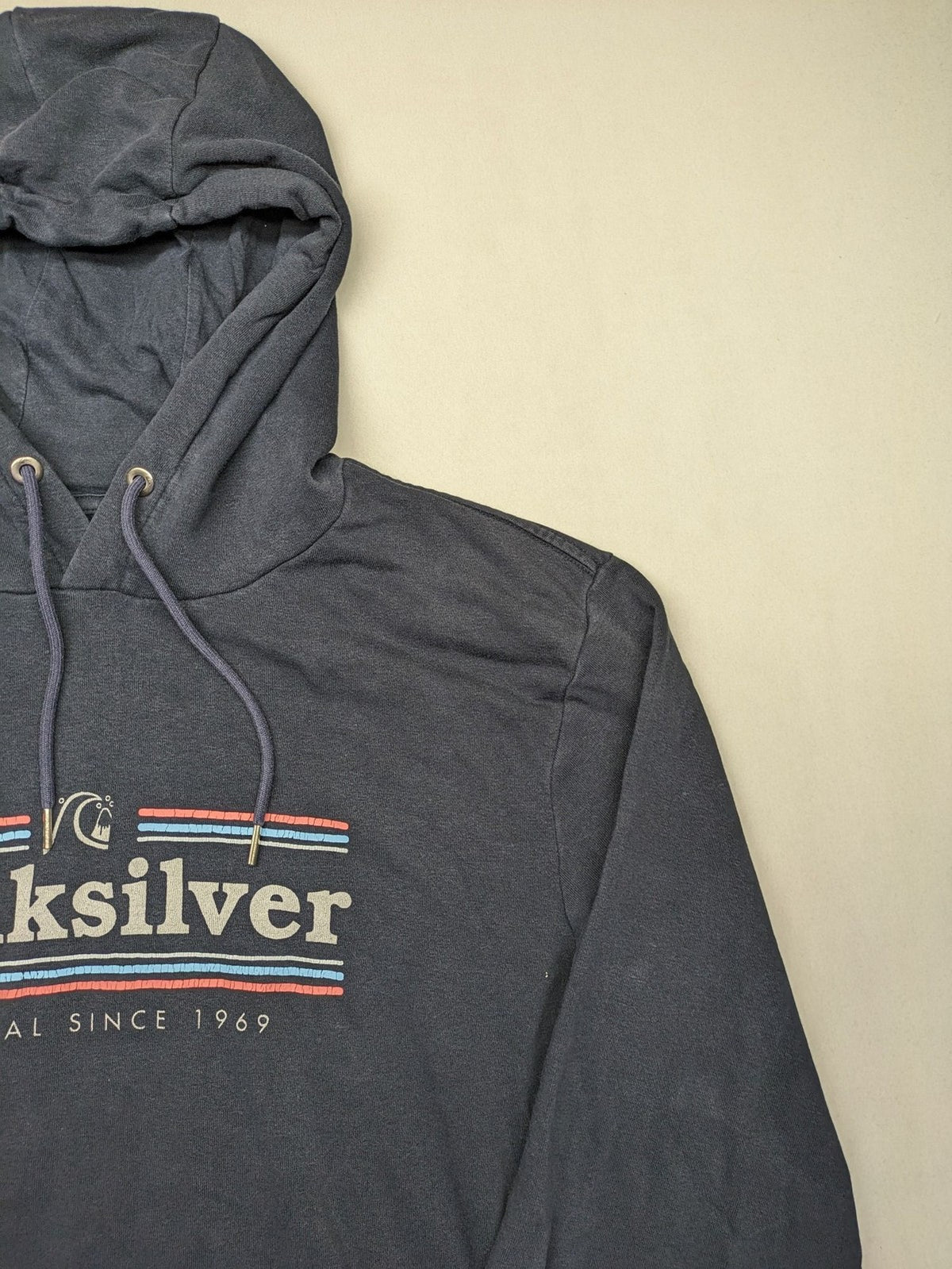 Quiksilver grey hoodie with logo graphic, kangaroo pocket, and adjustable hood.