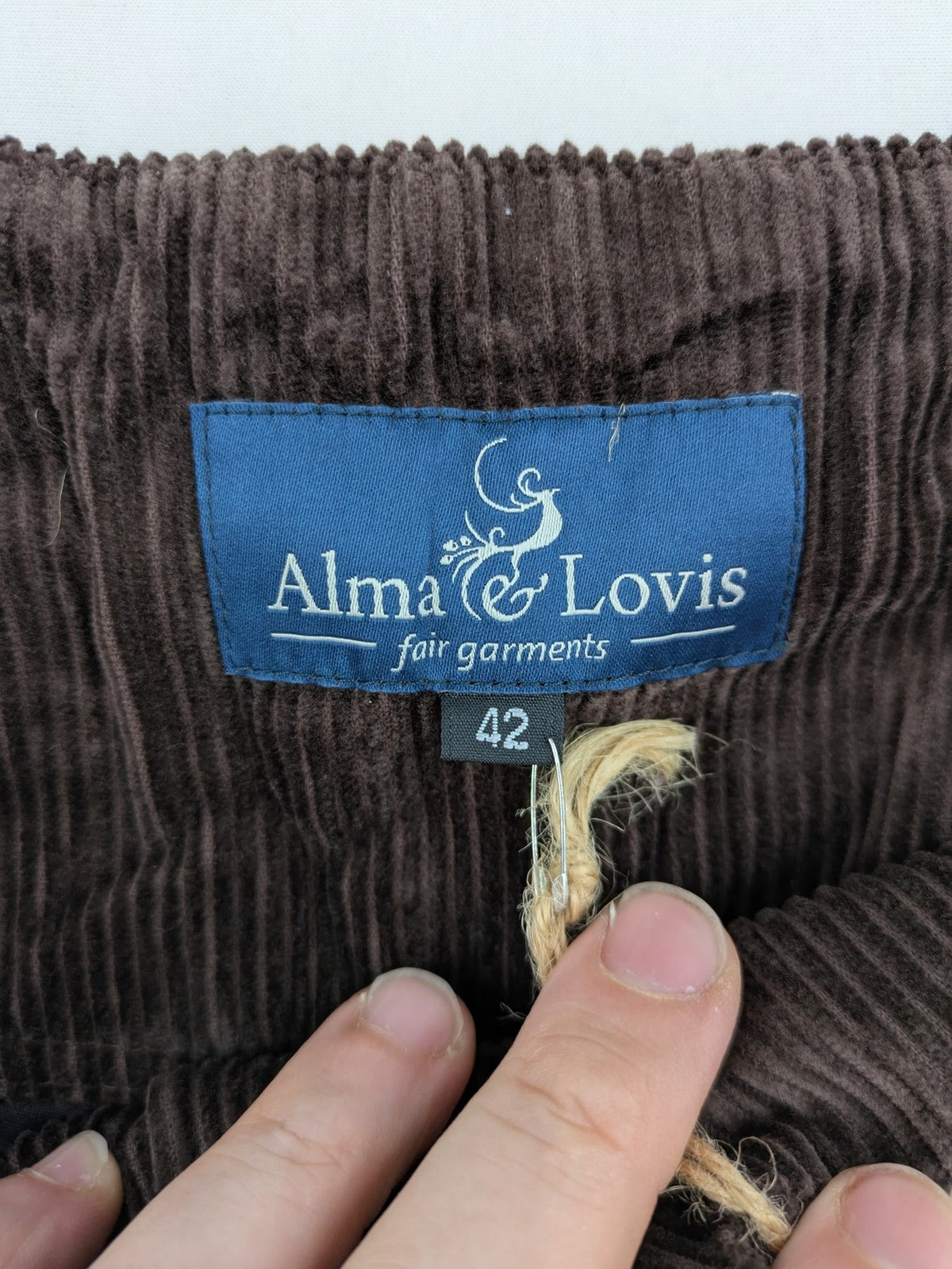Alma & Lovis brown cord pants with elastic waistband, drawstring, and front patch pockets.