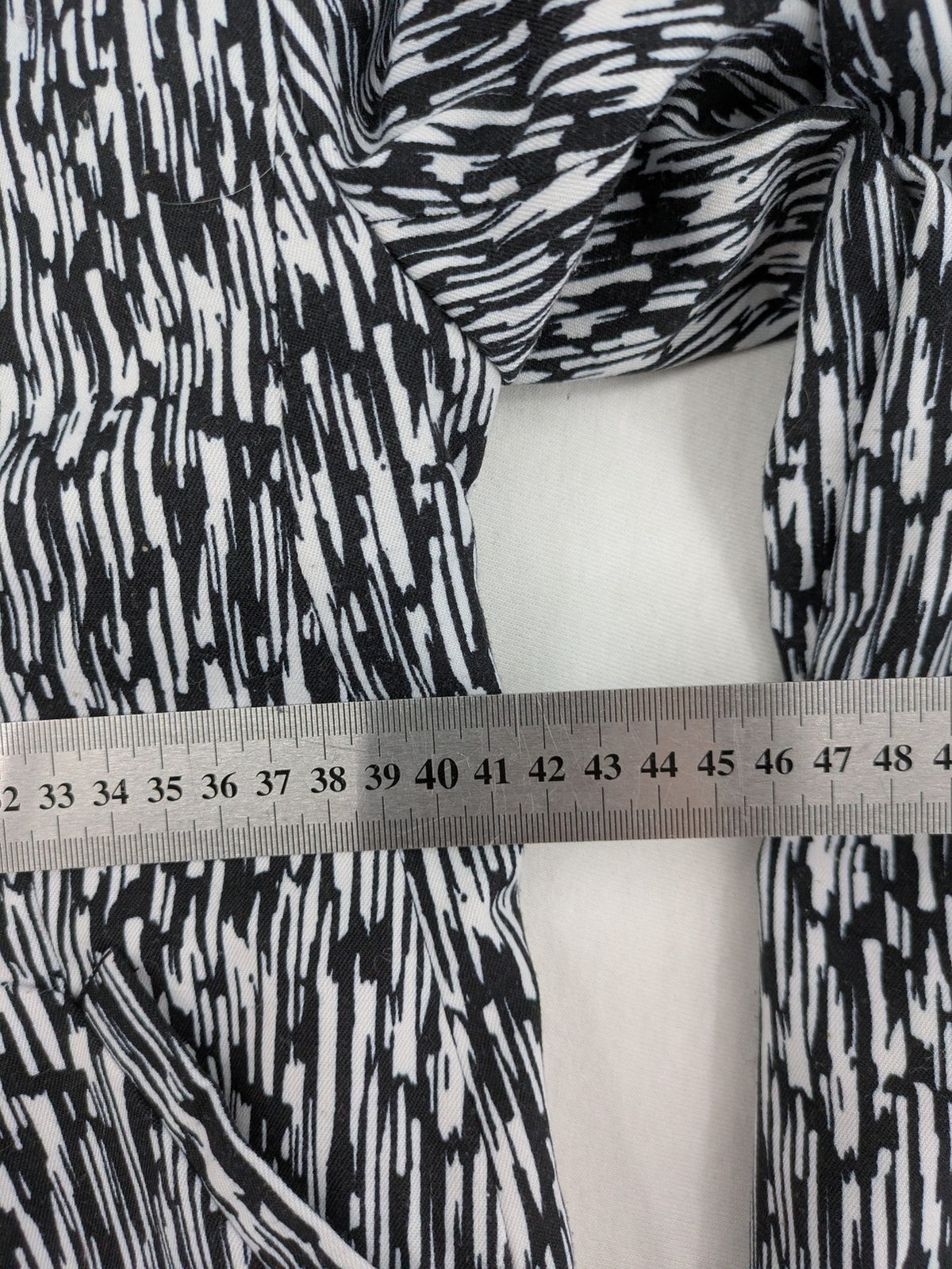 H&M Divided black and white patterned blazer with open front and two front pockets.