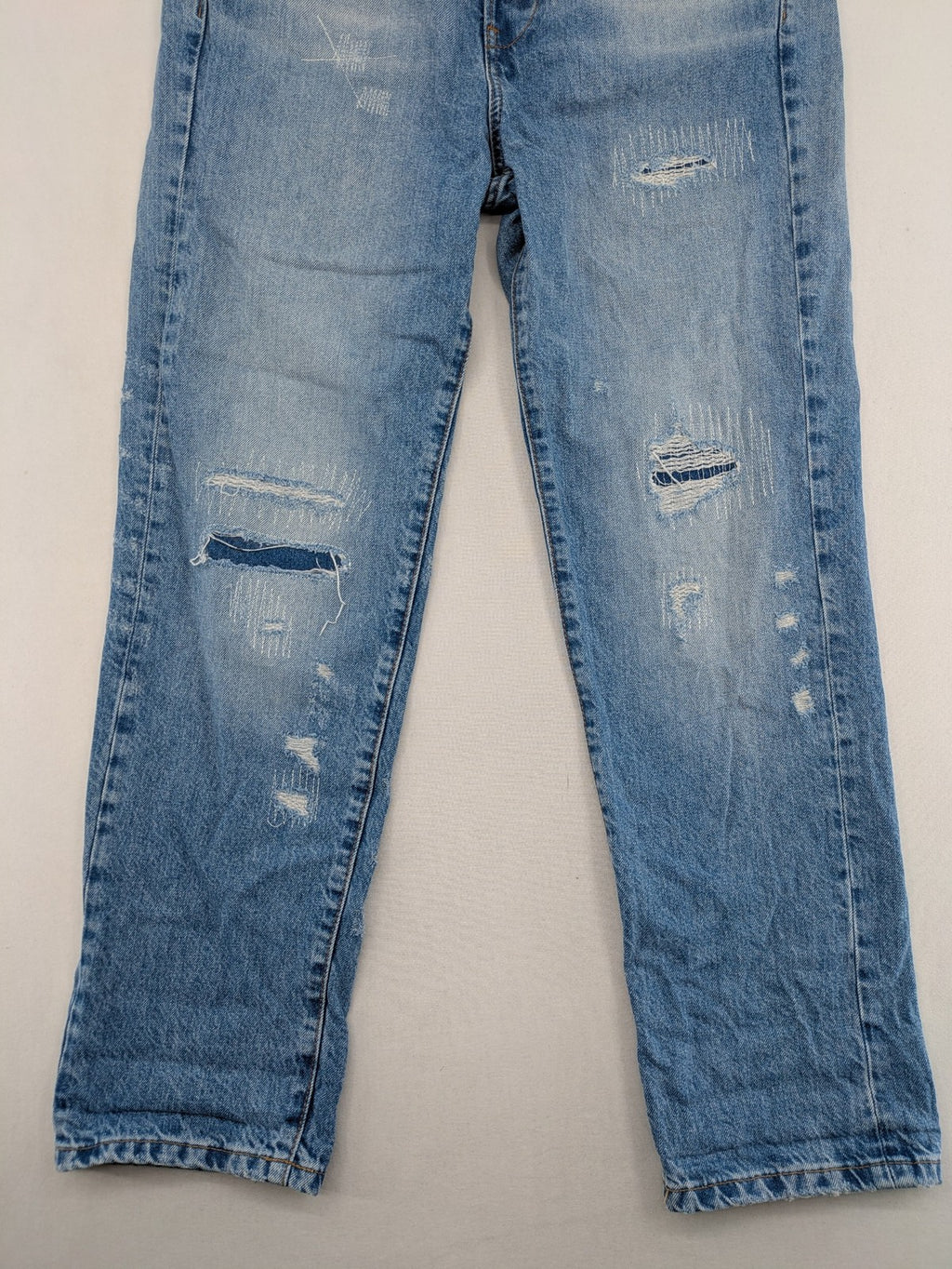 G-Star Raw blue distressed high boyfriend jeans with ripped details and classic button closure.
