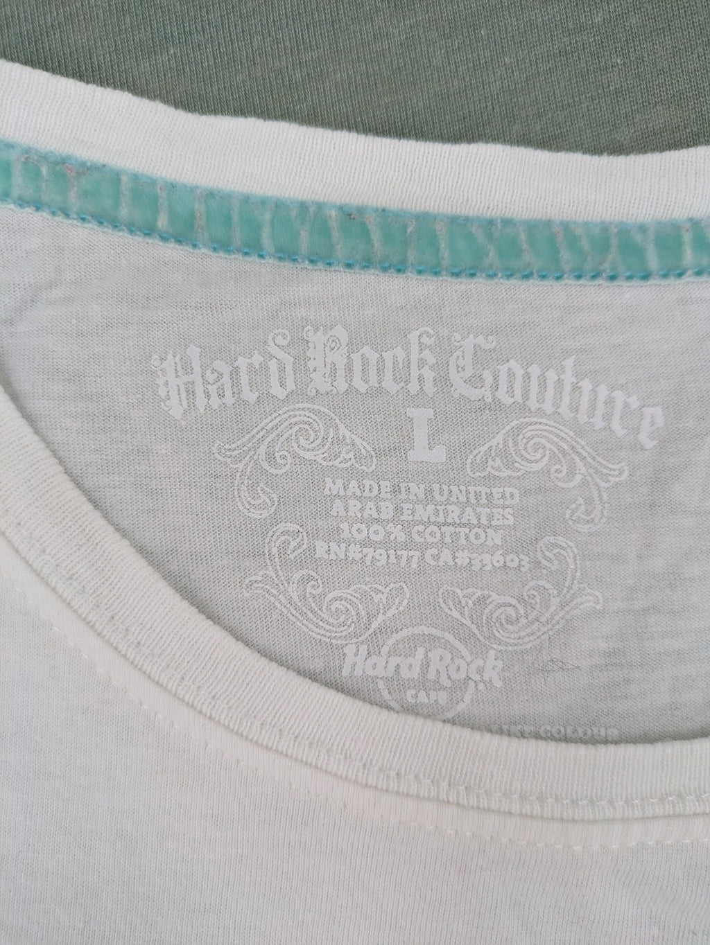 Hard Rock Cafe blue and white T-shirt with crown graphic and rhinestone accents.