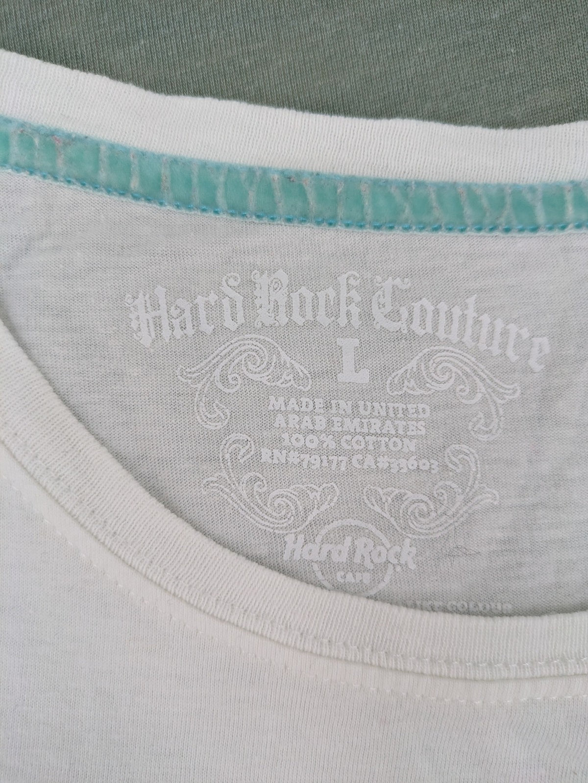 Hard Rock Cafe blue and white T-shirt with crown graphic and rhinestone accents.
