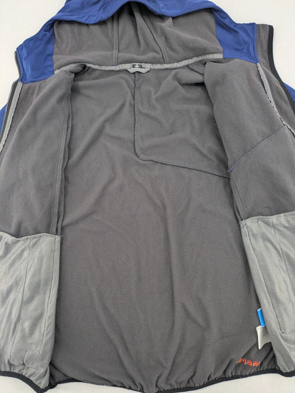 Firefly blue softshell jacket with adjustable hood and prominent chest logo.