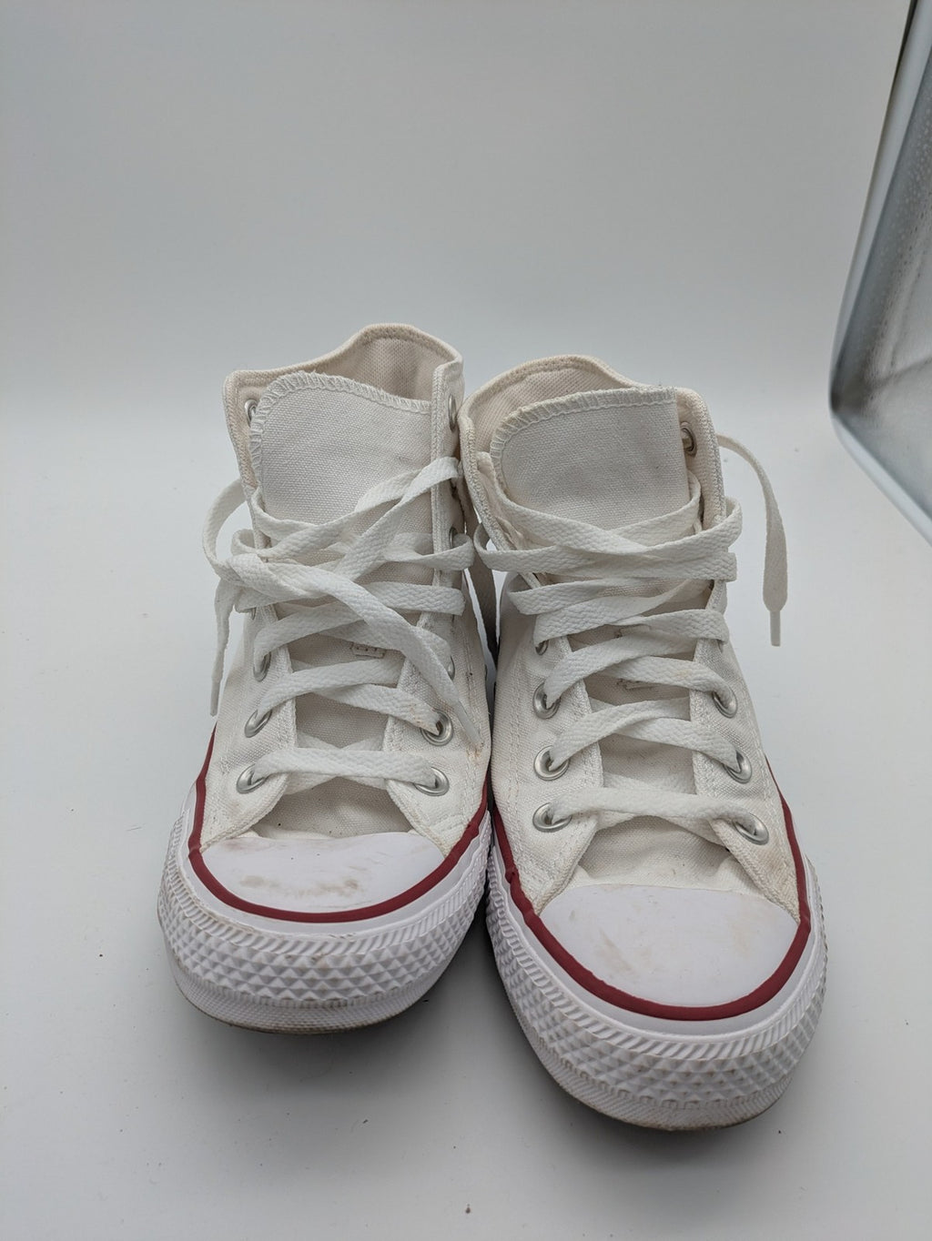 Converse Chuck Taylor All Star high top sneakers black canvas with red and white accents.