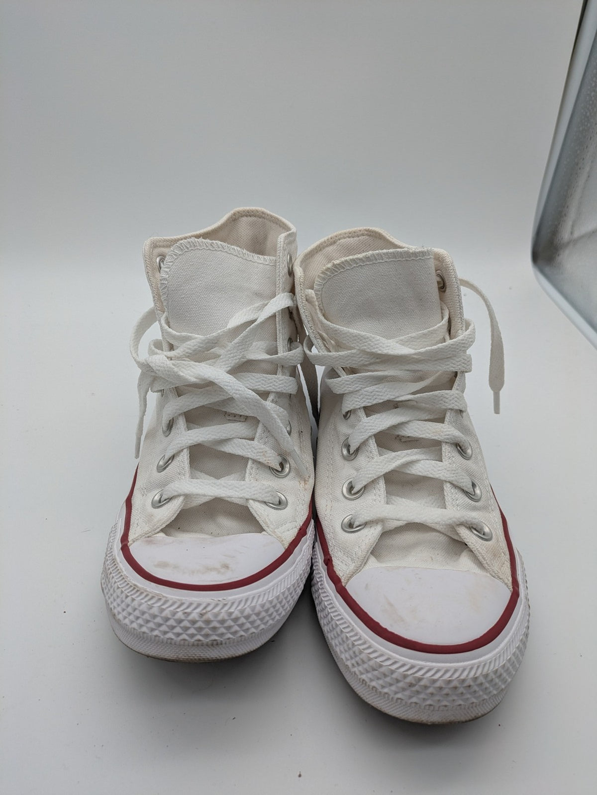 Converse Chuck Taylor All Star high top sneakers black canvas with red and white accents.