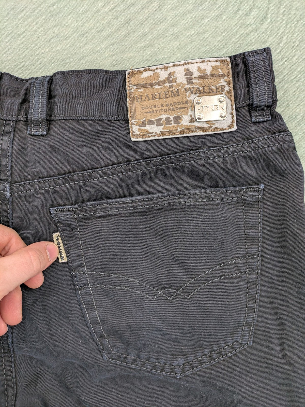 Joker black straight jeans five-pocket design with prominent stitching and brand details.