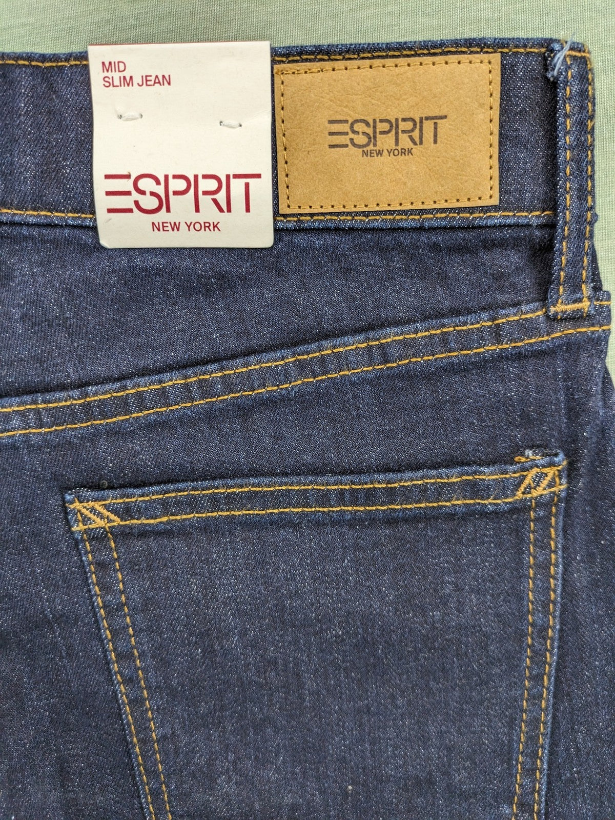 Esprit navy straight jeans with five-pocket style and yellow contrast stitching.
