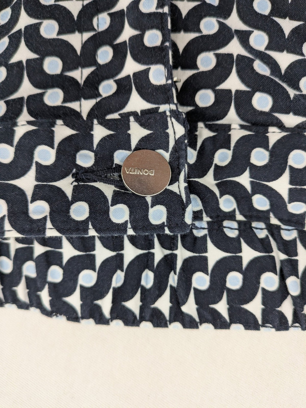 Bonita navy pants with geometric pattern, stretch material, and classic zip fly closure.