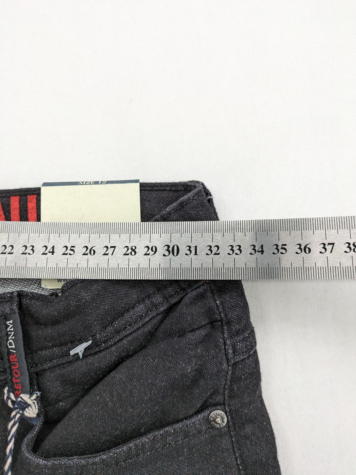 Skinny black straight jeans with distressed details and logo, made from durable denim.