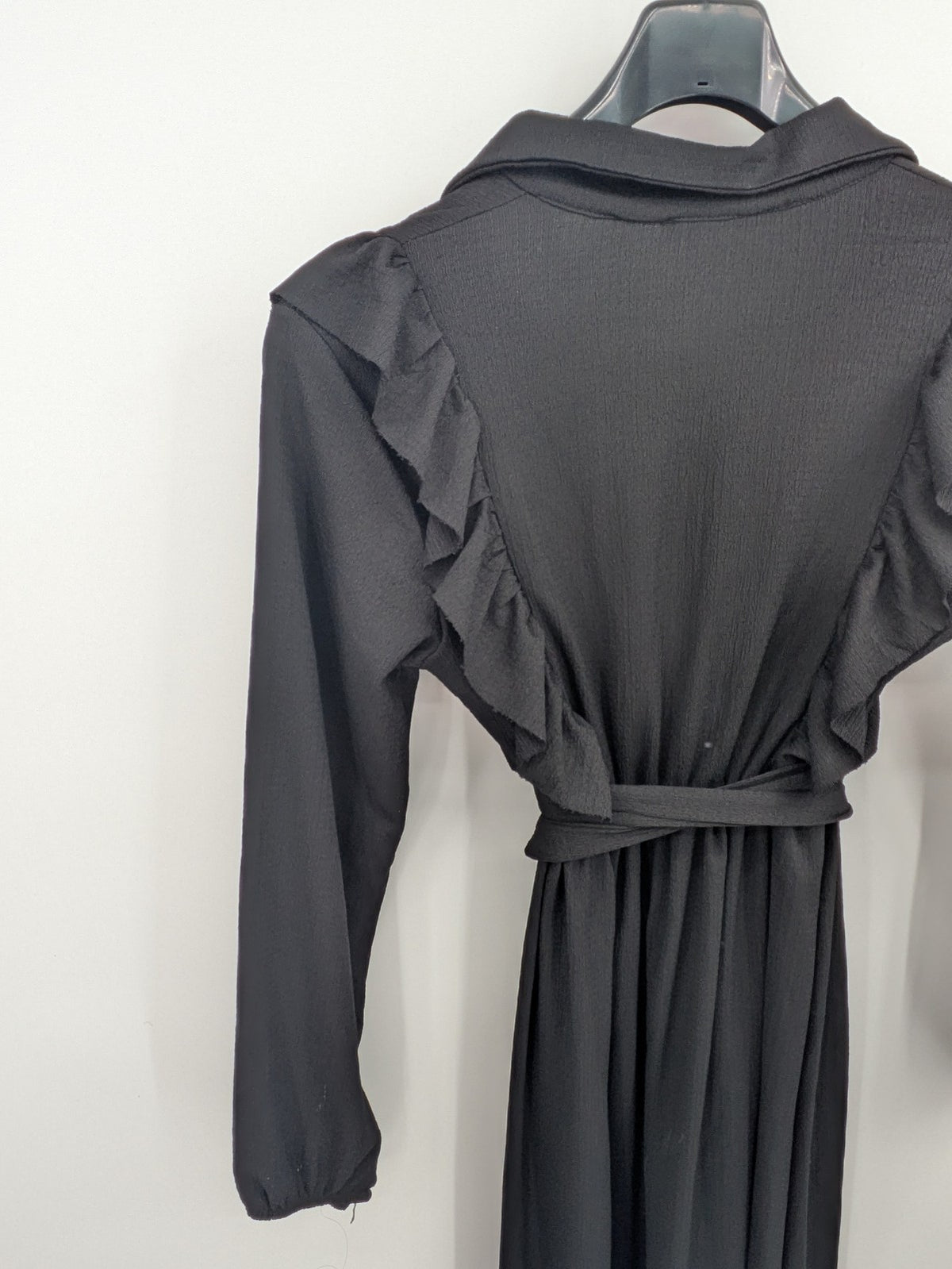 Hakke black maxi dress with ruffle details, long sleeves, and matching belt.
