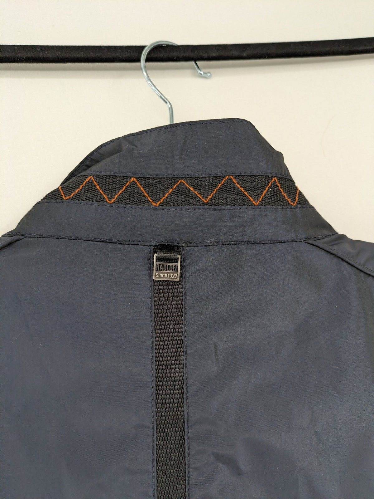 Radloff grey navy bomber jacket with orange contrast stitching and zippered pockets.