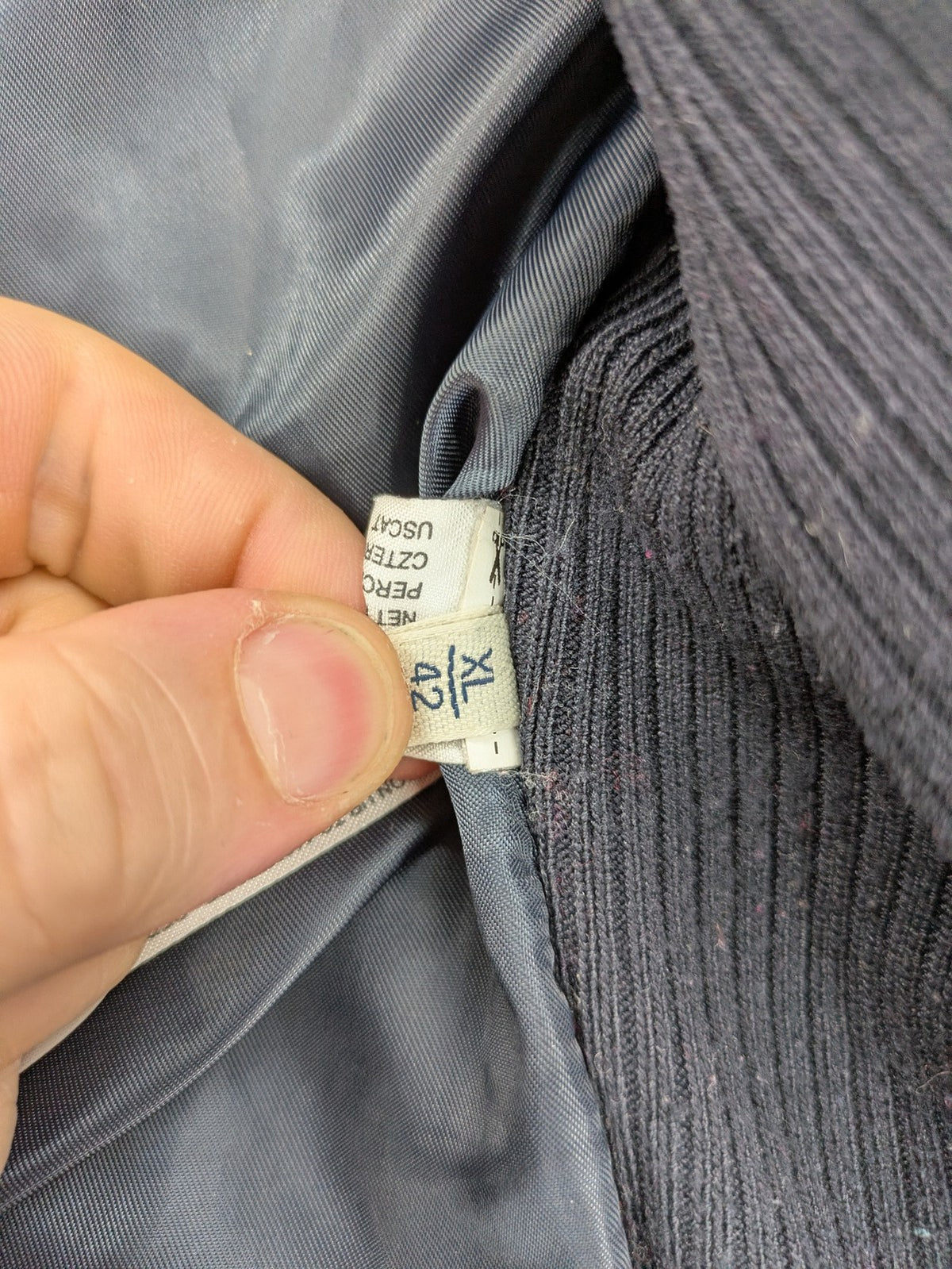 Massimo Dutti black quilted jacket with contrasting brown trim and ribbed side inserts.