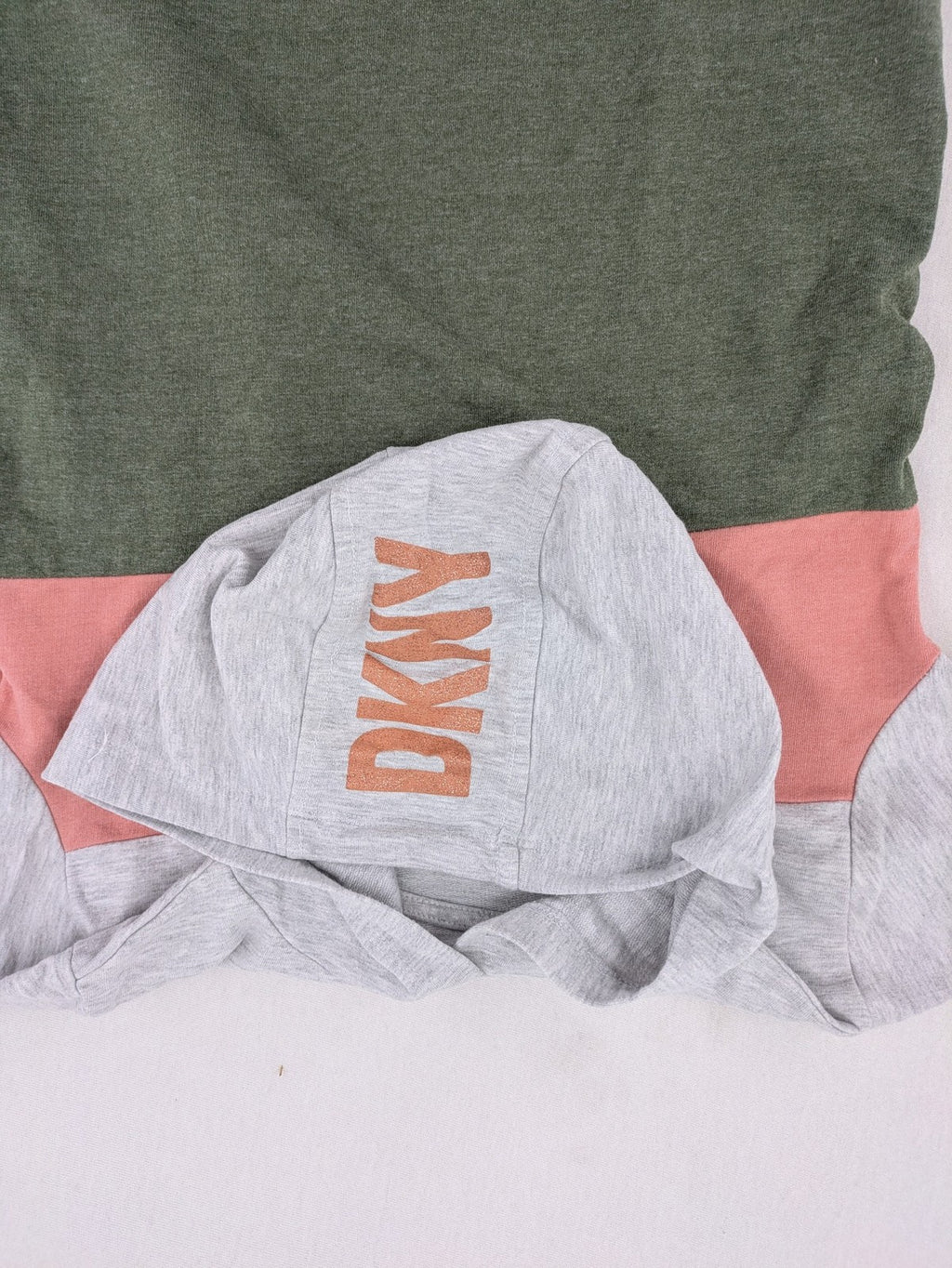DKNY pink hoodie dress colorblock design with glitter logo and short sleeves.