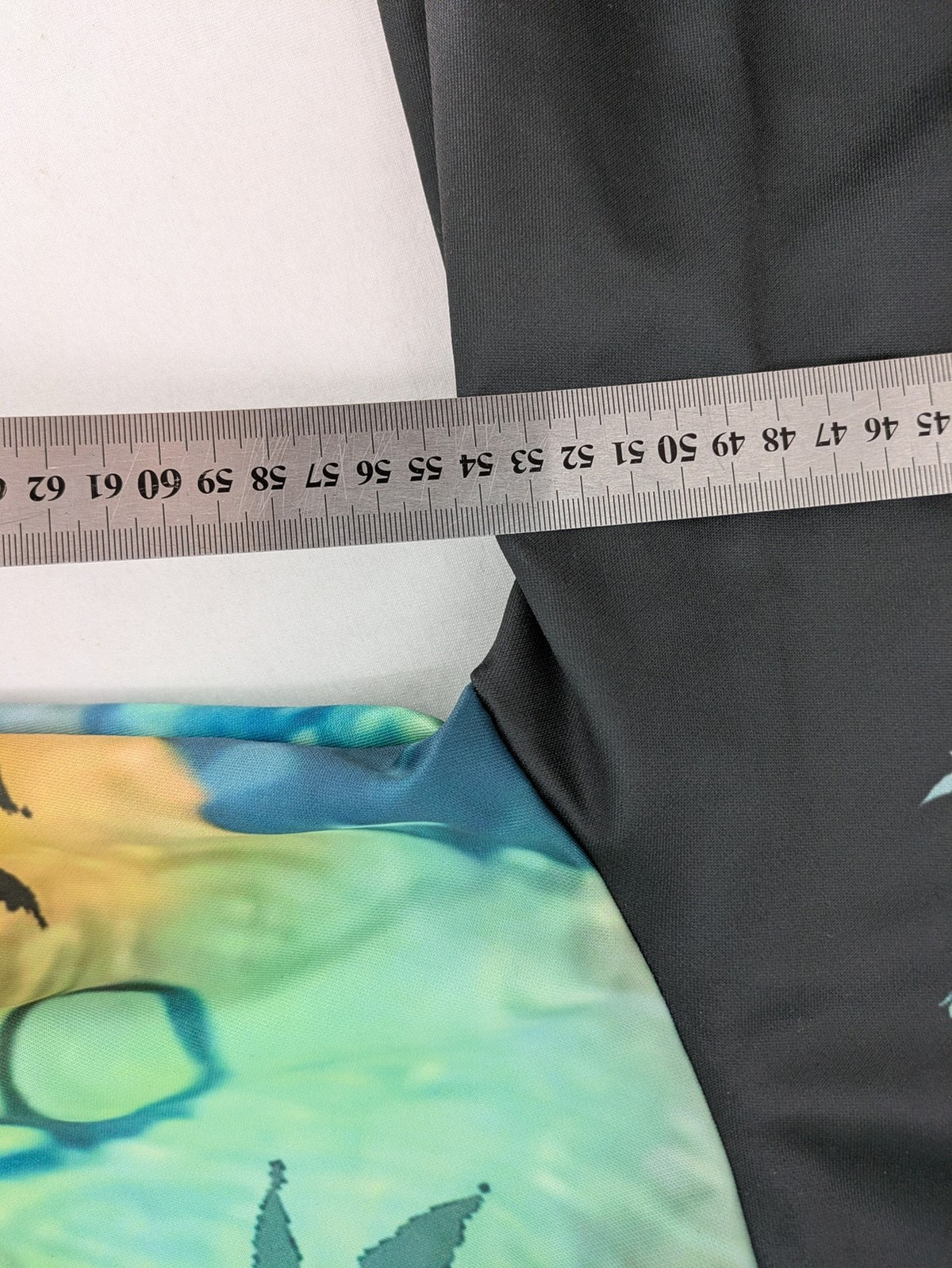 Skull tie-dye hoodie blue green with cannabis leaf graphic and bold text.