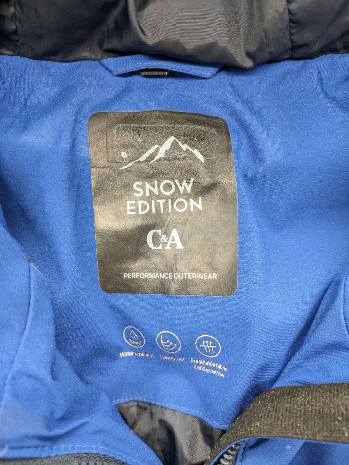 C&A blue winter jacket with hood, zip closure, and multiple pockets, used condition.