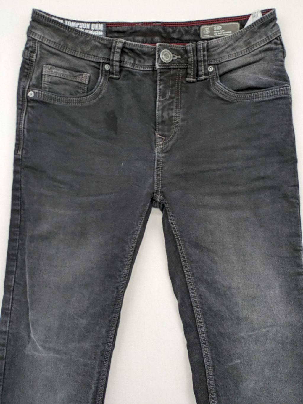 Tom Tompson grey slim tapered jeans with washed denim finish and subtle branding.