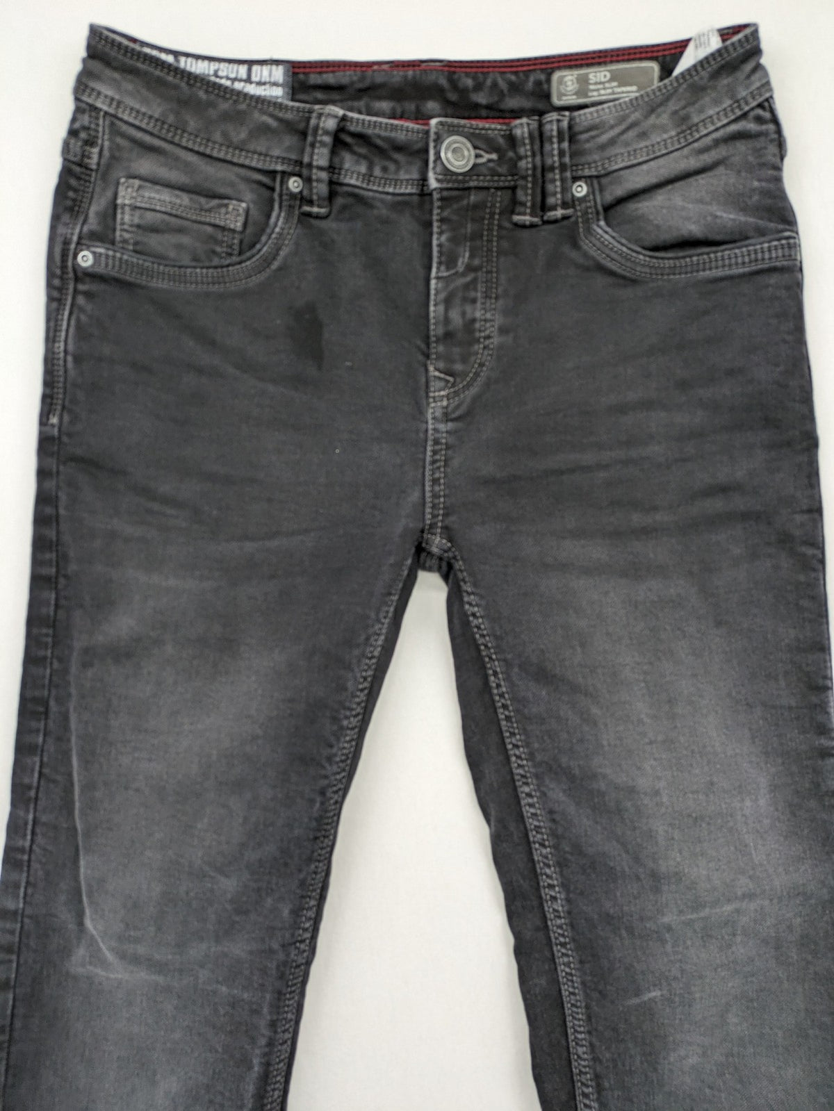 Tom Tompson grey slim tapered jeans with washed denim finish and subtle branding.