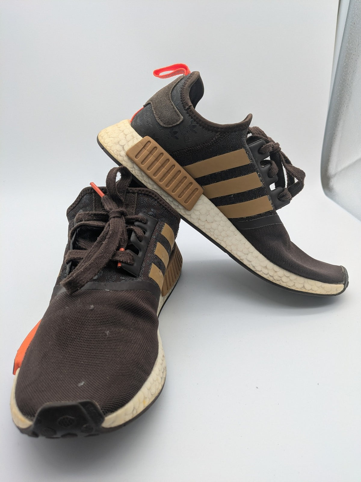 Adidas NMD R1 sneakers brown with tan stripes and bright orange accents, Boost sole.