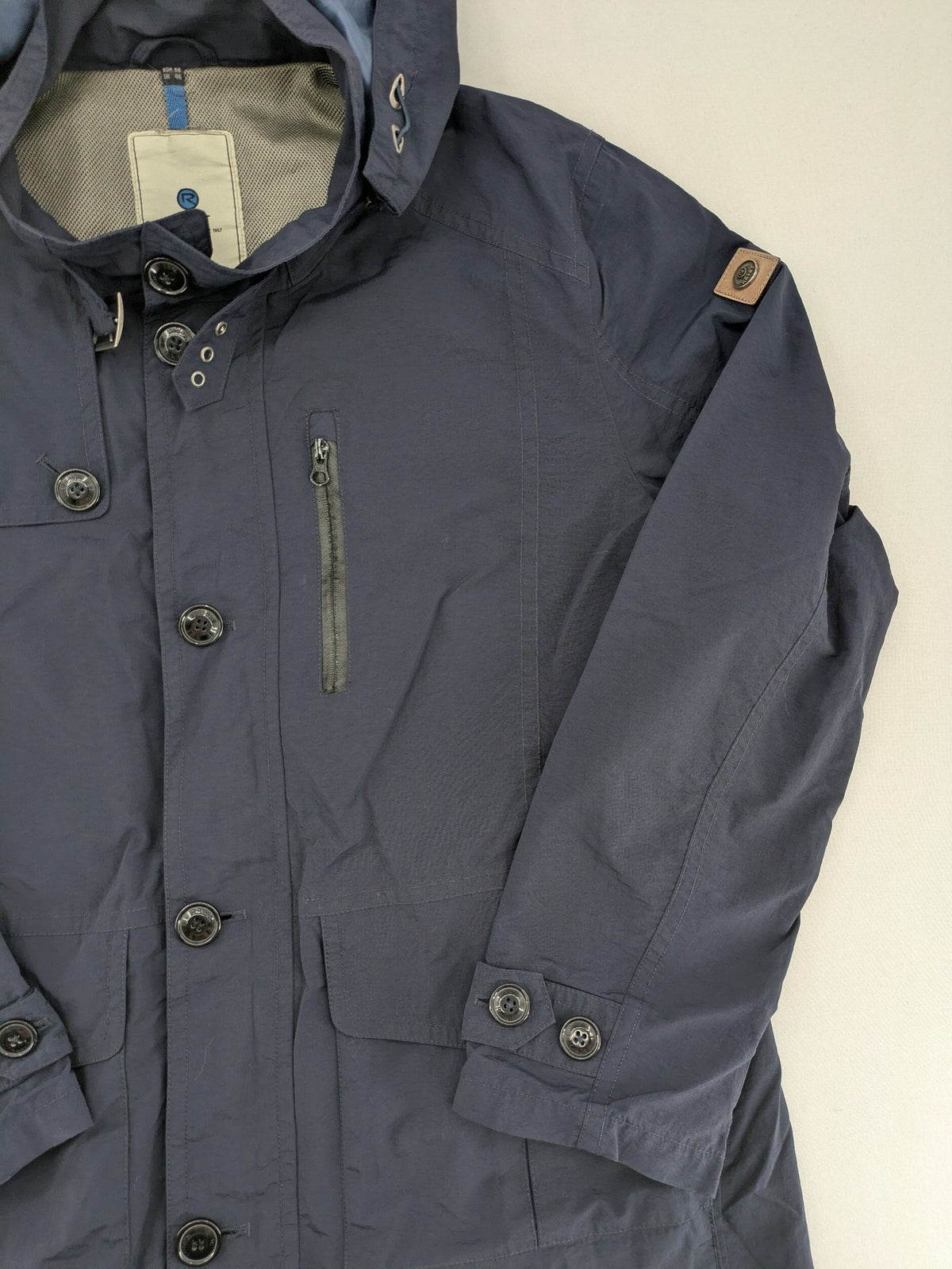 Reset navy parka jacket windproof with adjustable hood and zippered chest pocket.