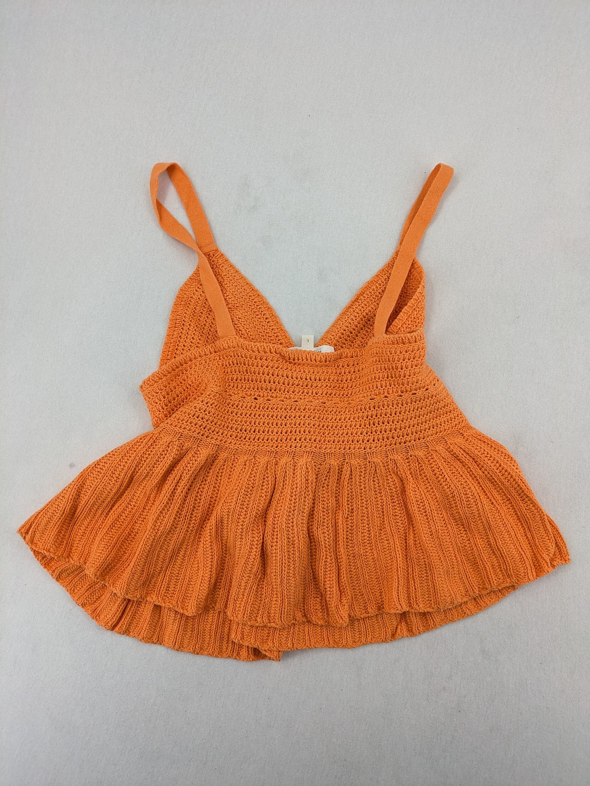 REVIEW orange crochet top with V-neck and peplum hem, made from 100% cotton.