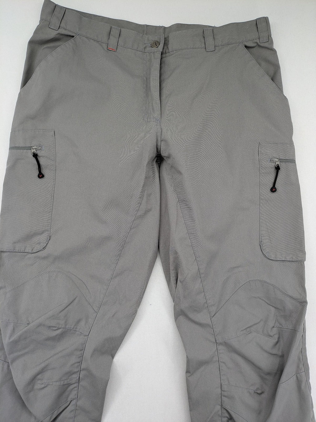 YETI grey cargo pants with multiple zippered pockets and durable material.