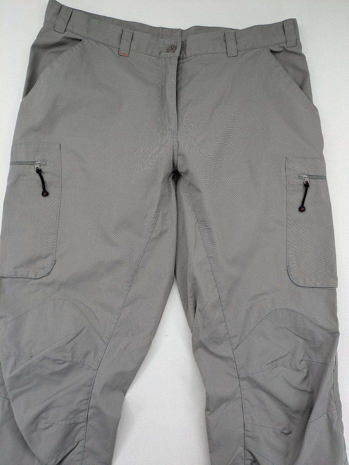 YETI grey cargo pants with multiple zippered pockets and durable material.