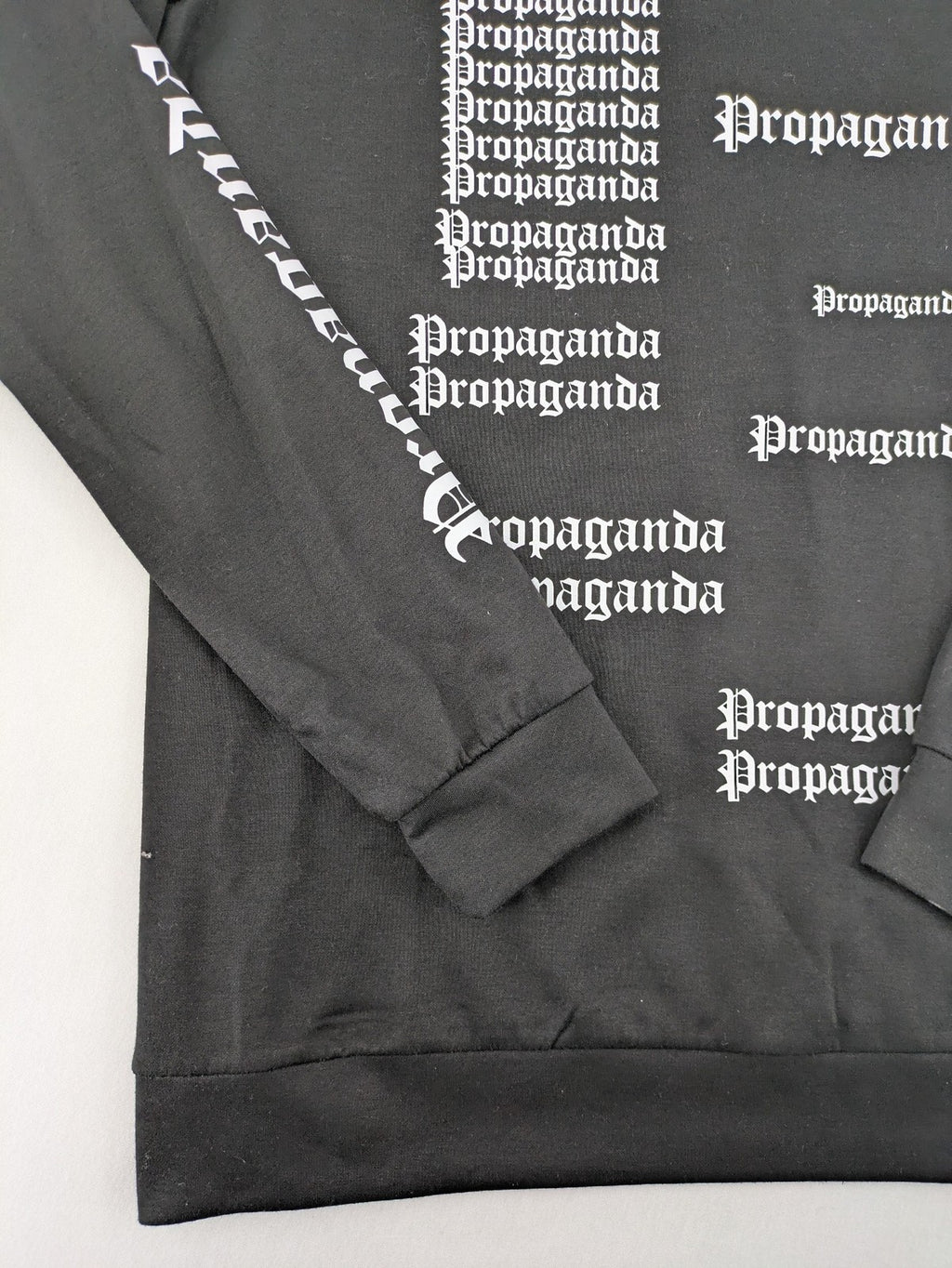 Sixth June black sweatshirt with Gothic "Propaganda" graphic print and logo details.