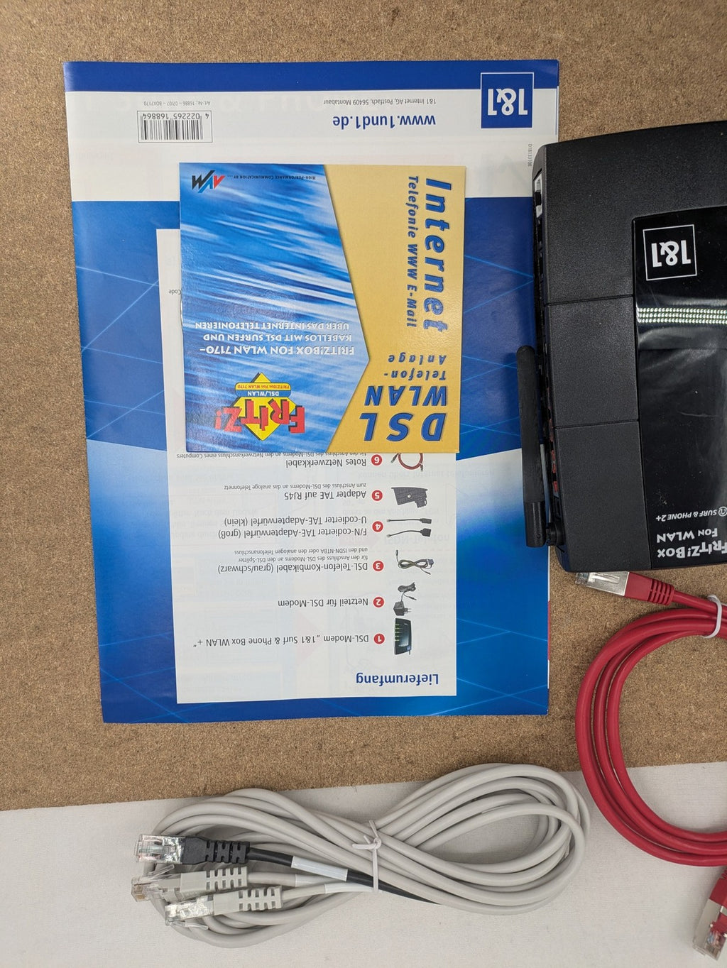 AVM VoIP gateway router blue with integrated DSL modem and phone system features.