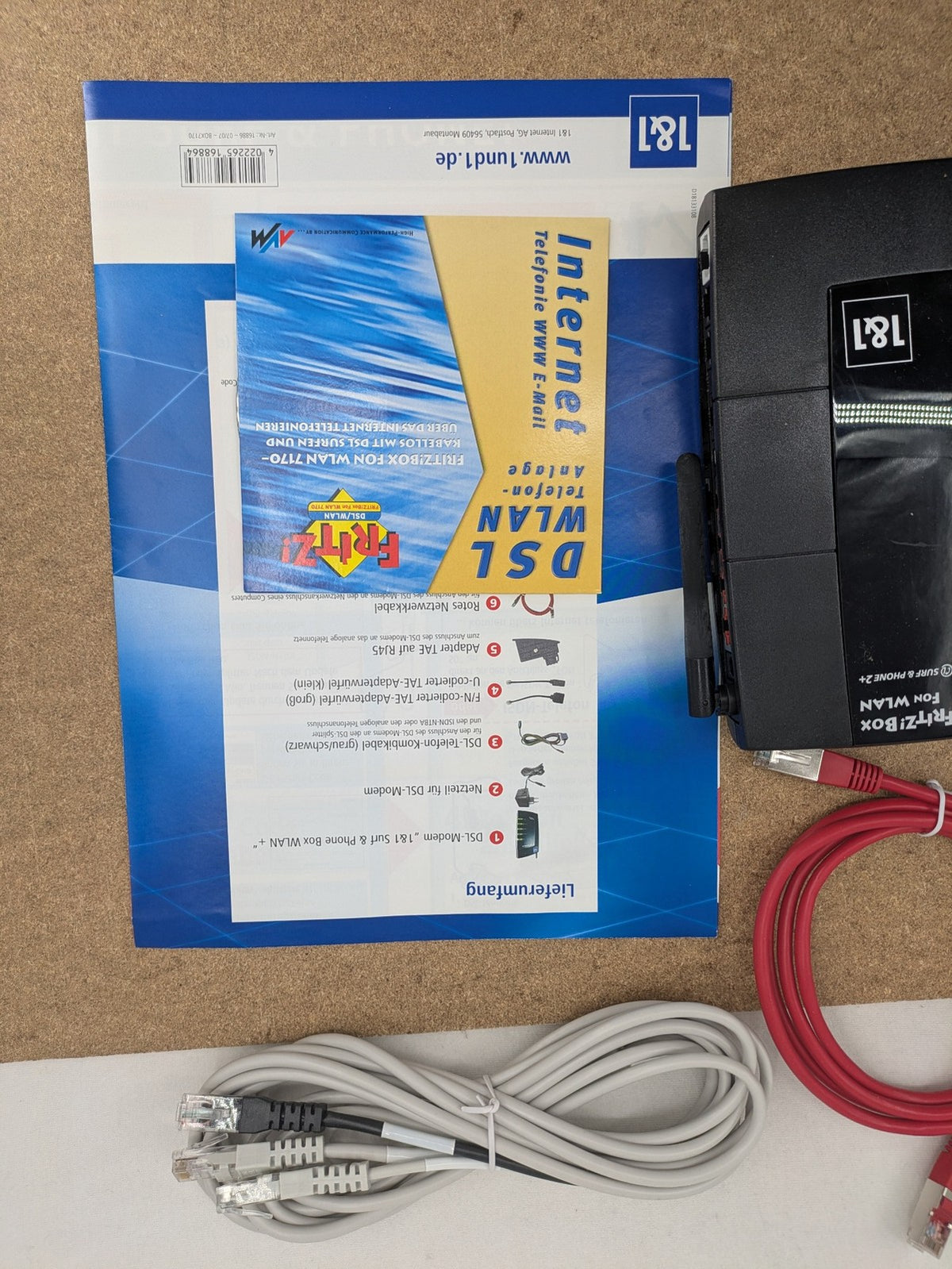 AVM VoIP gateway router blue with integrated DSL modem and phone system features.