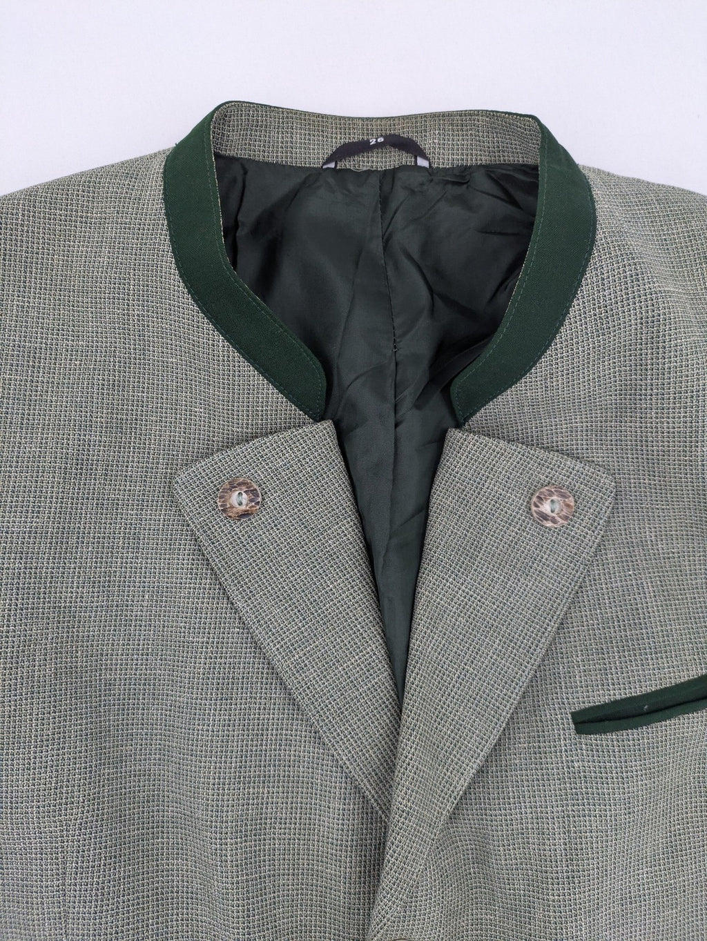 Traunsee Trachten green jacket with standing collar, decorative buttons, and premium wool-linen blend.