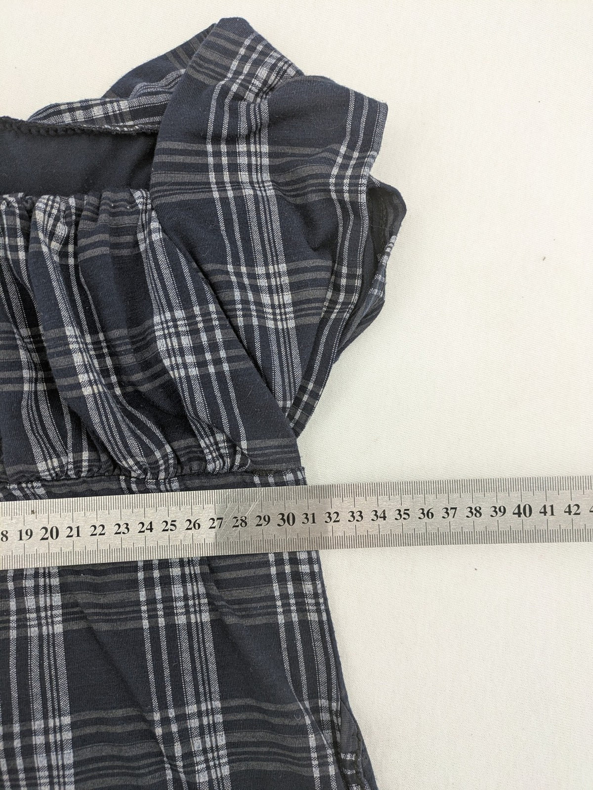 Eleganz navy and white checked top with square neckline and gathered bust detail.