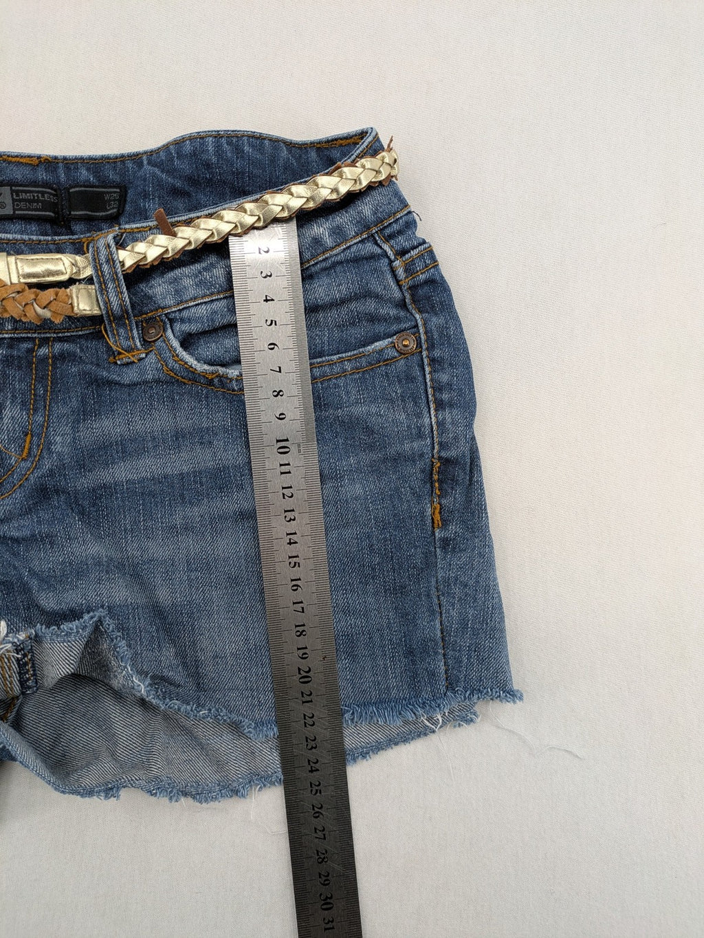 ONLY cream denim shorts with frayed hem and decorative braided gold belt