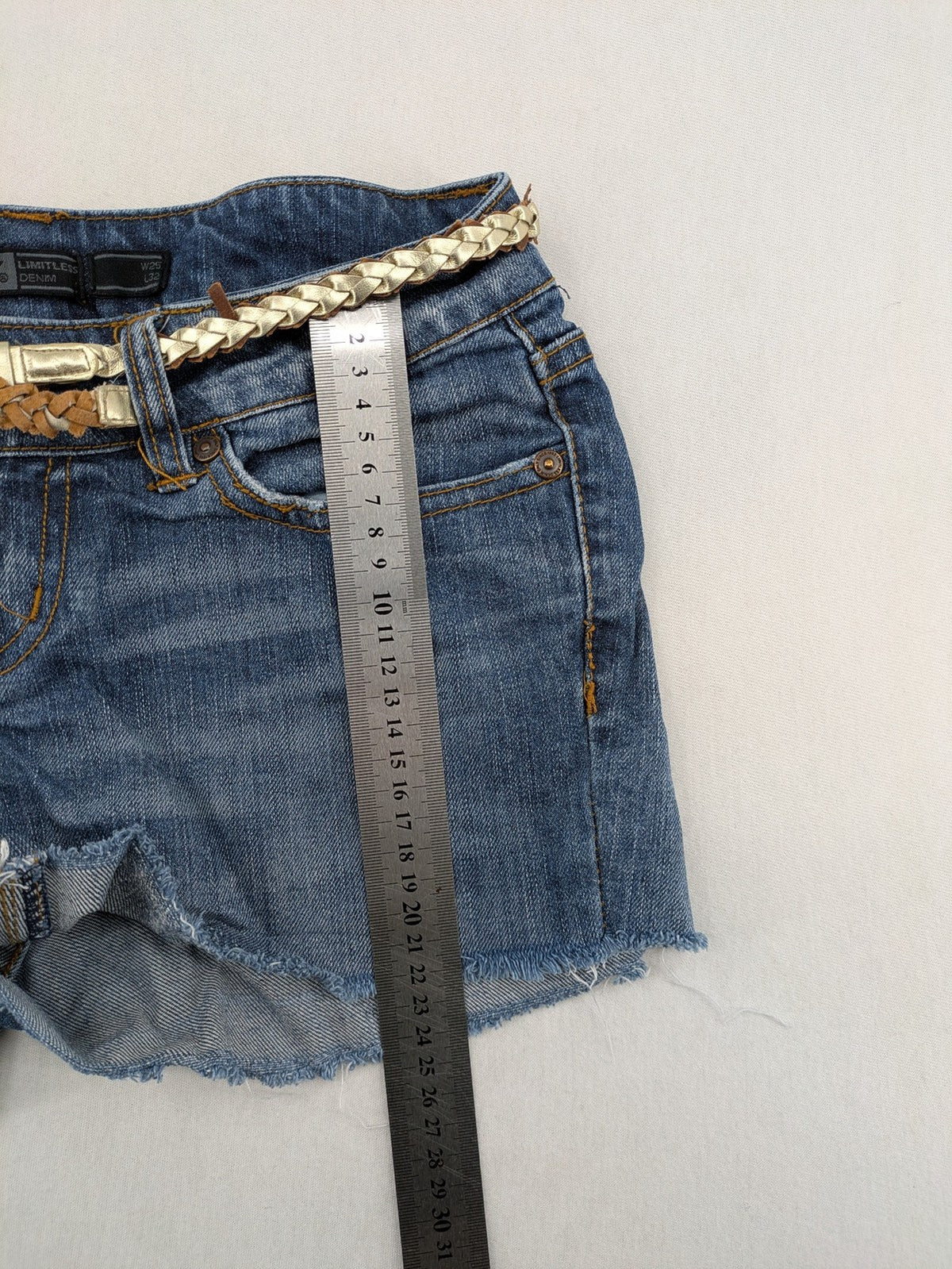 ONLY cream denim shorts with frayed hem and decorative braided gold belt