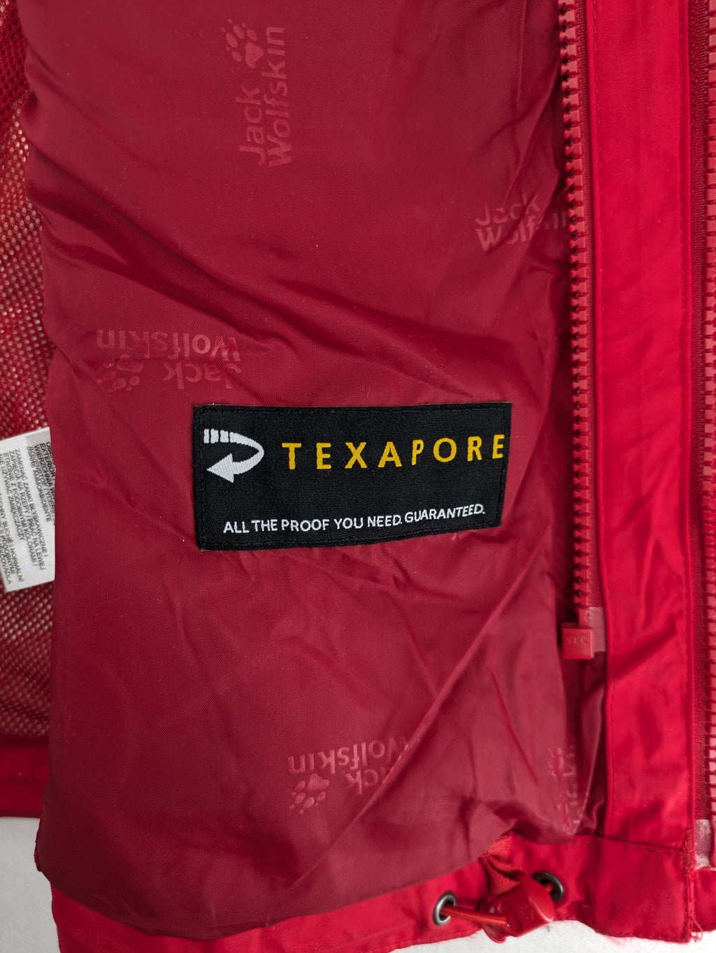Jack Wolfskin red outdoor jacket with adjustable hood and Texapore waterproof technology