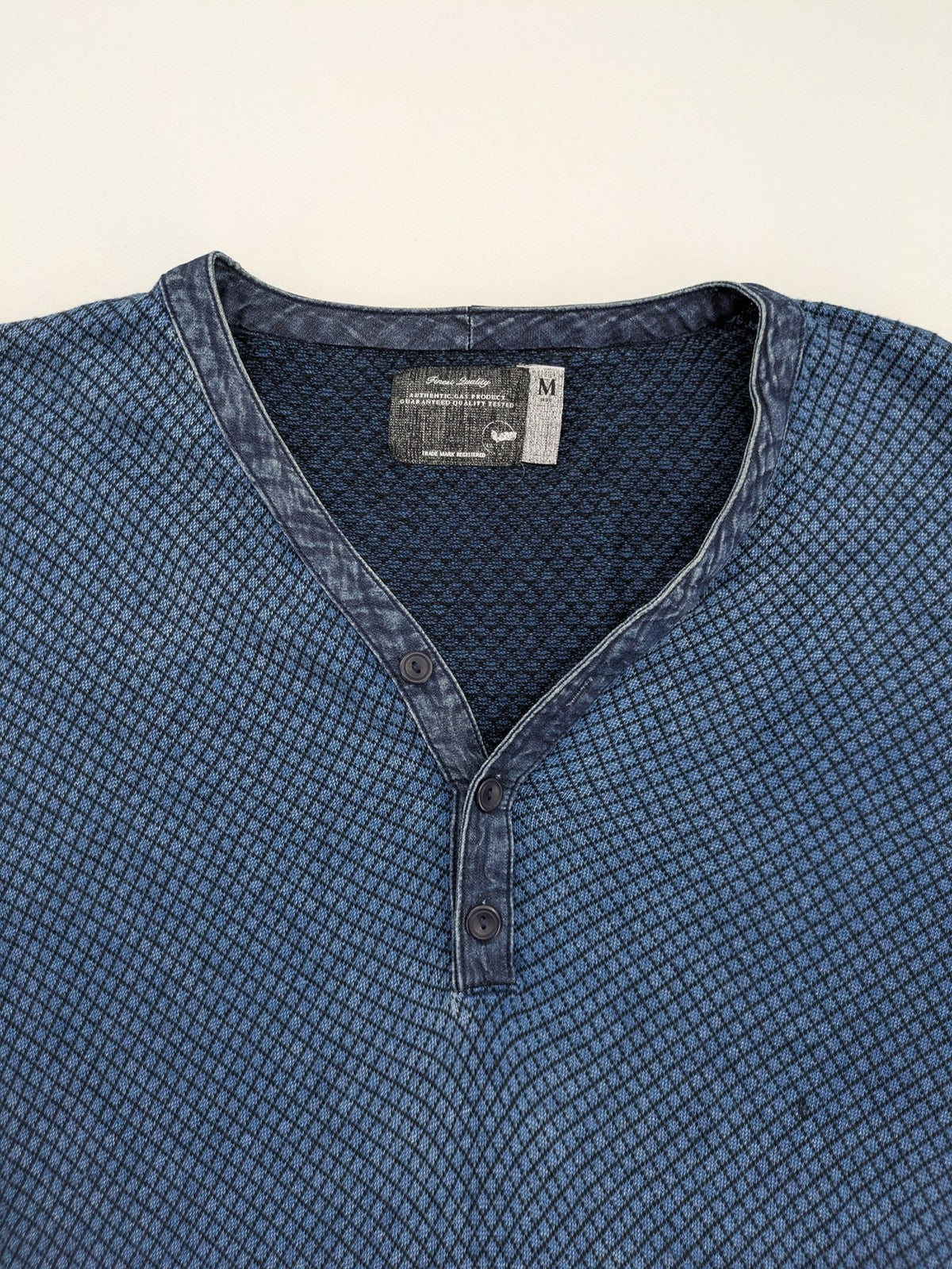 Gas blue turtle neck jumper with diamond pattern, three-button Henley neck, and contrasting trim.