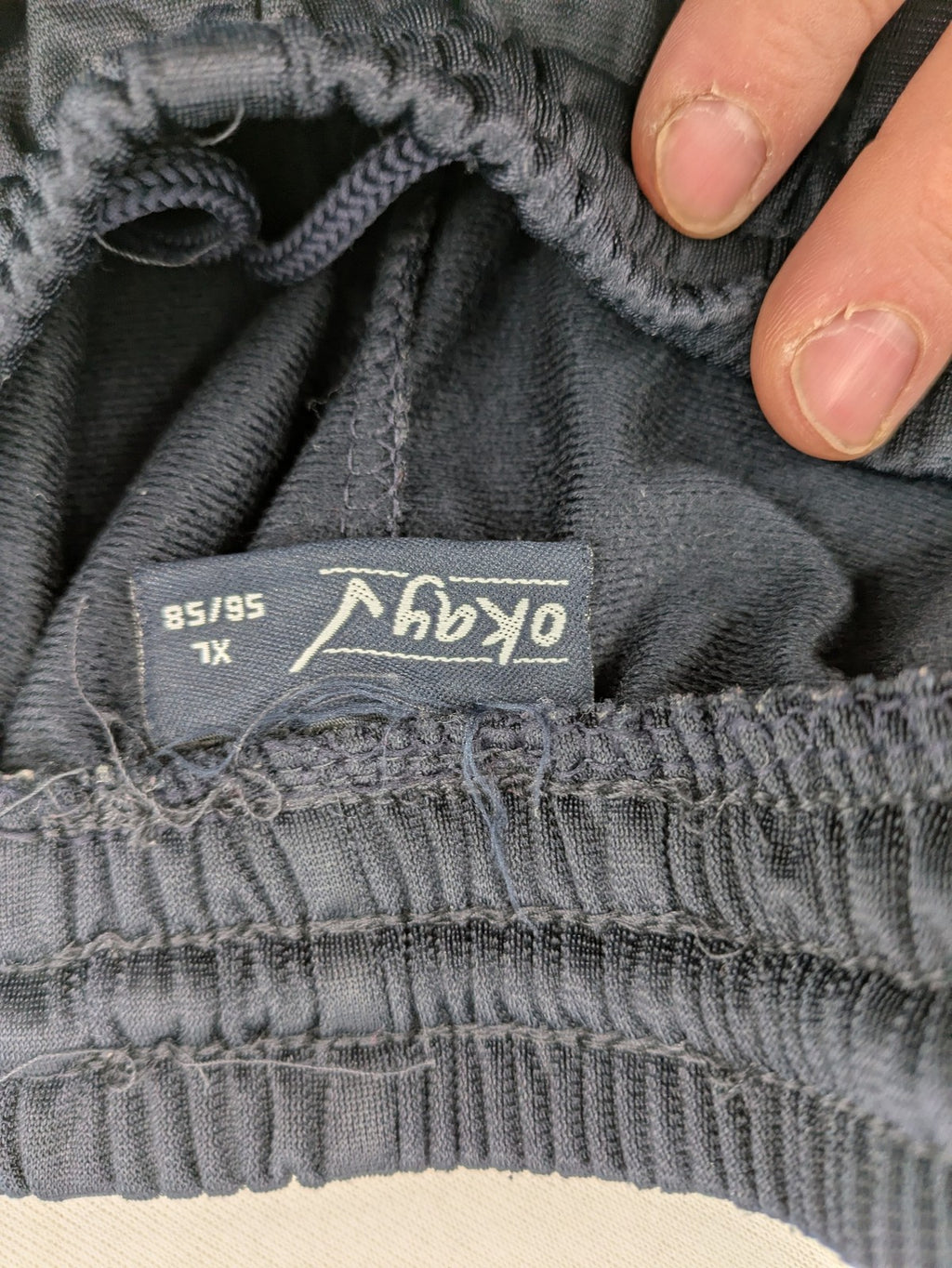 okay grey cargo shorts with green "ATHL. 5 DIVISION" graphic print and side pocket.