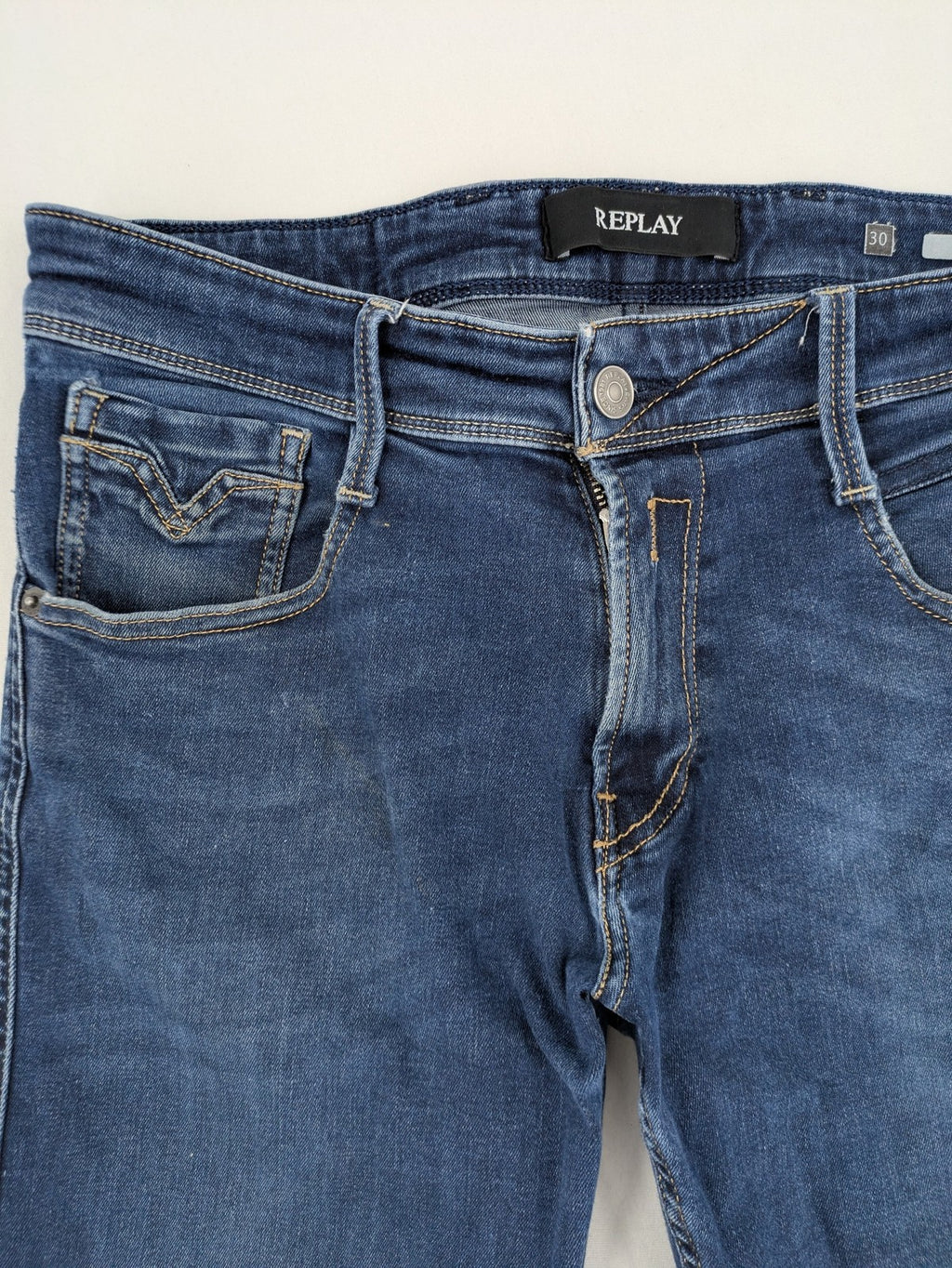 Replay slim fit jeans blue with subtle fading and stretch denim material.