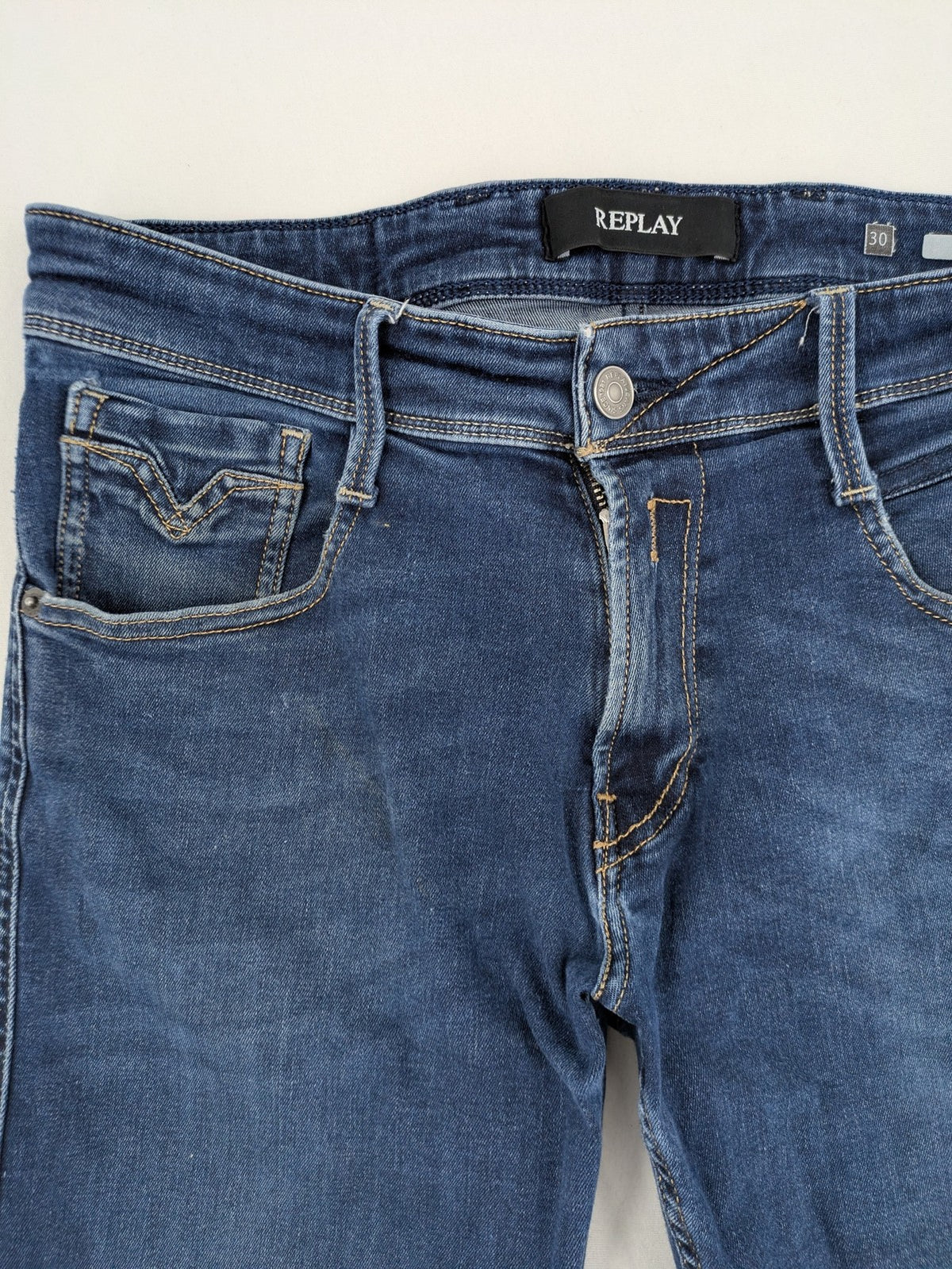 Replay slim fit jeans blue with subtle fading and stretch denim material.