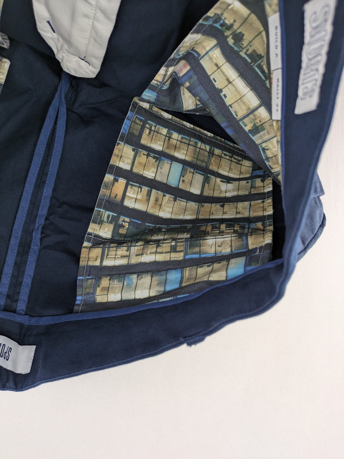 Spoke navy chino shorts flat front with unique printed pocket lining.