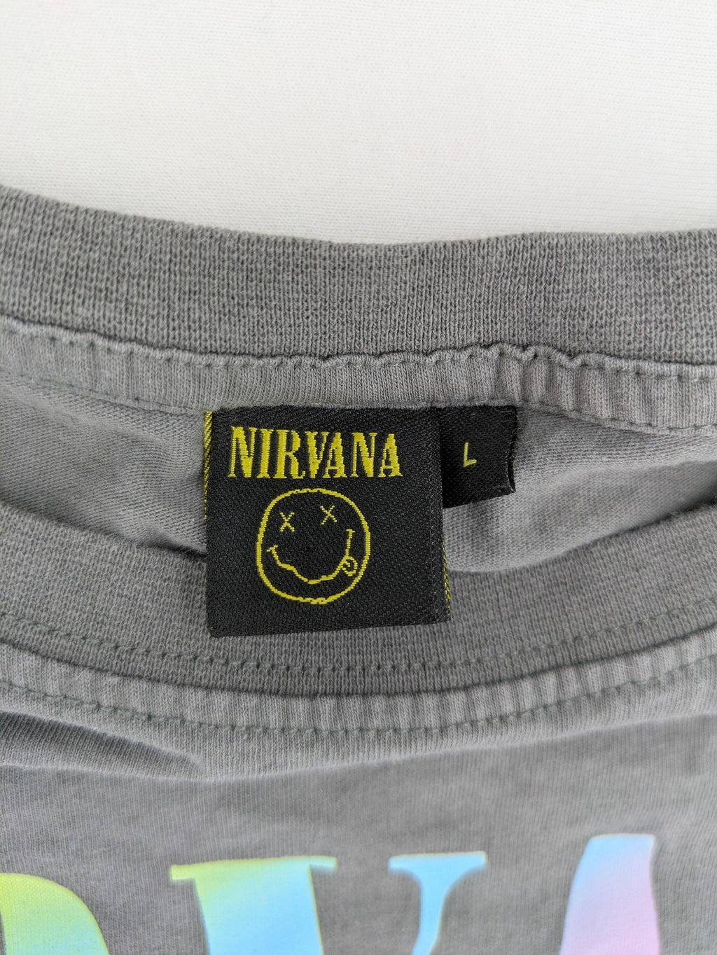 Nirvana grey t-shirt with rainbow Smiley logo and "Come As You Are" text.