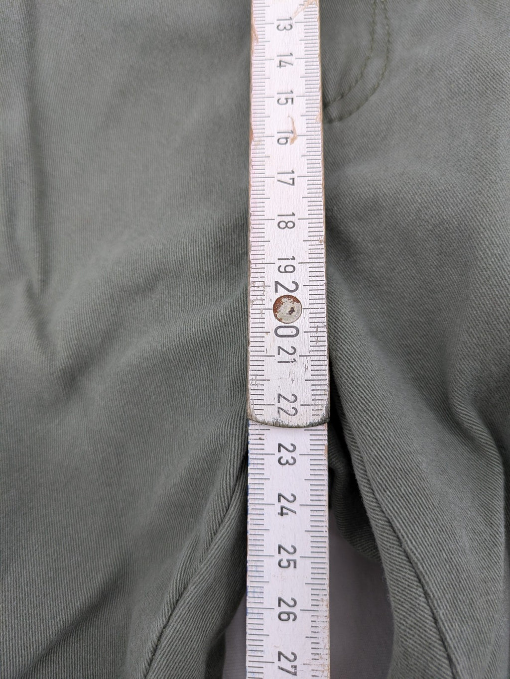 Page One Young khaki motorcycle pants with stitched panels and decorative zipper details.