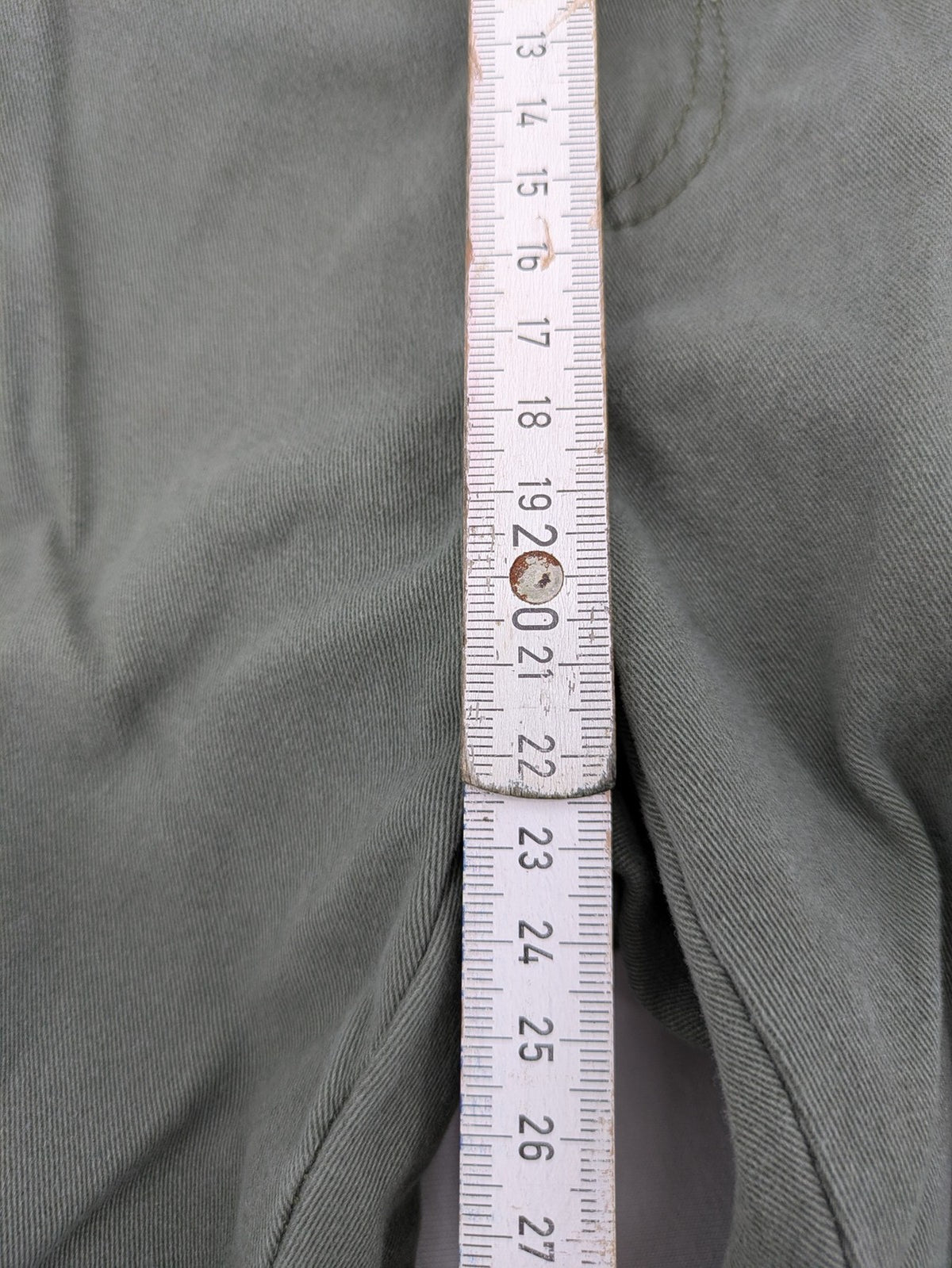 Page One Young khaki motorcycle pants with stitched panels and decorative zipper details.