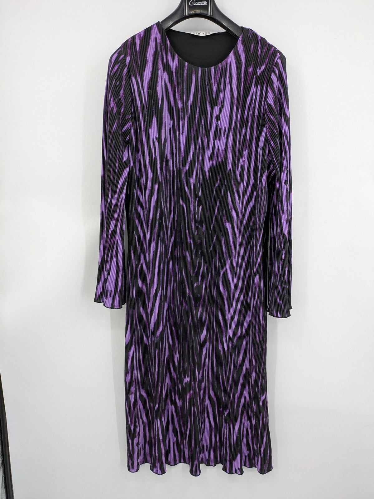 Untold black and purple pleated dress with animal print pattern and long sleeves.