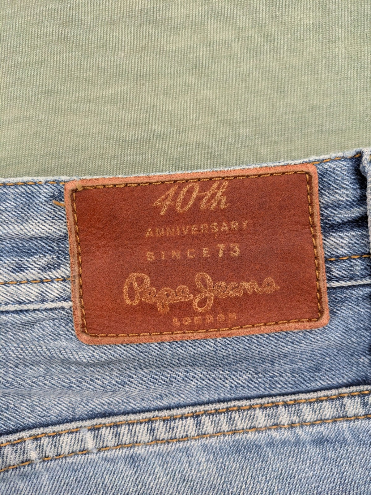 Pepe Jeans blue straight jeans with Union Jack embroidery and distressed denim finish.