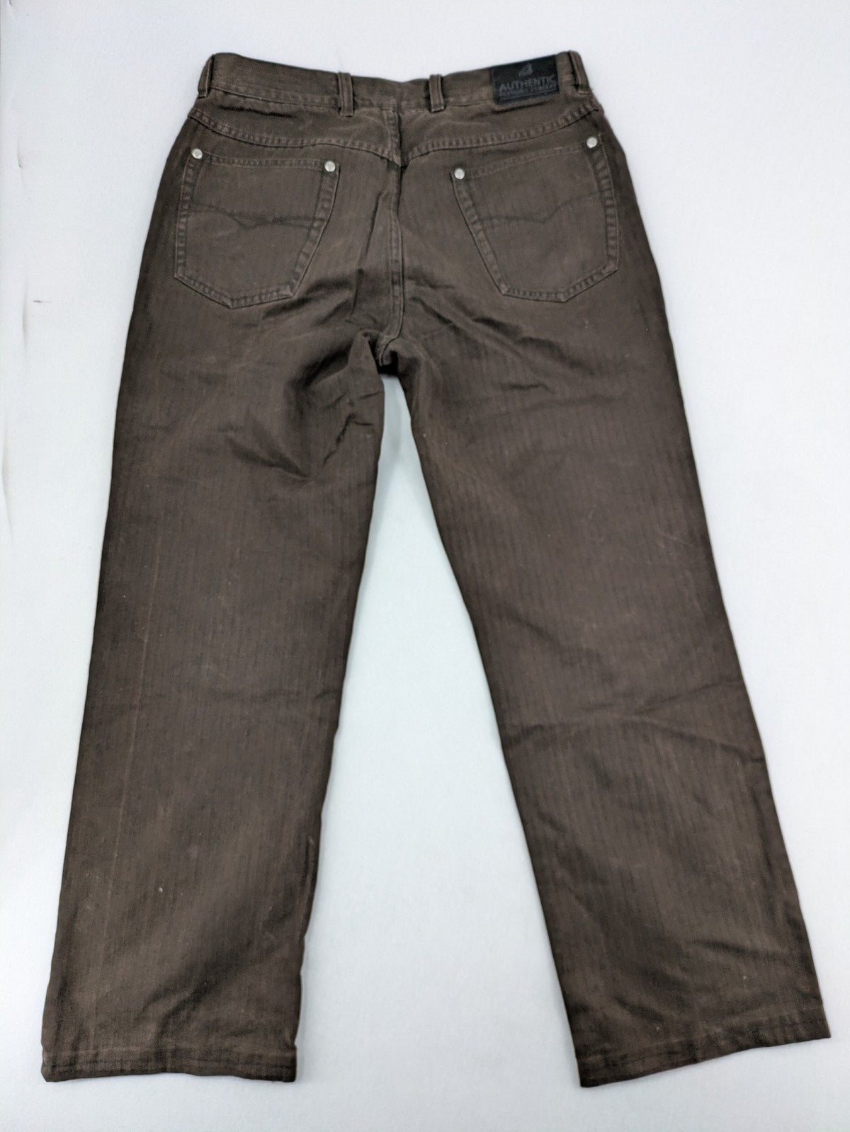 Authentic Clothing Company brown straight jeans with subtle stripe pattern and brand patch.