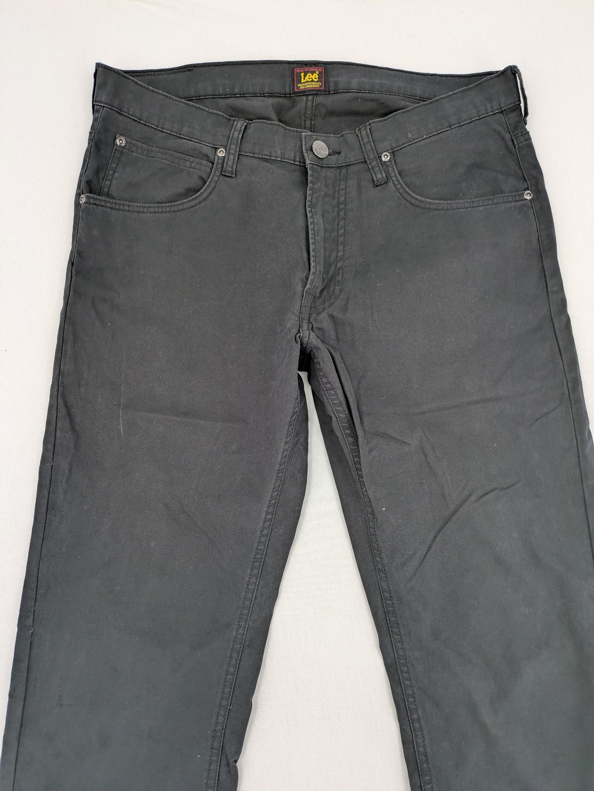 Lee straight jeans grey classic 5-pocket design with zip fly and subtle branding.